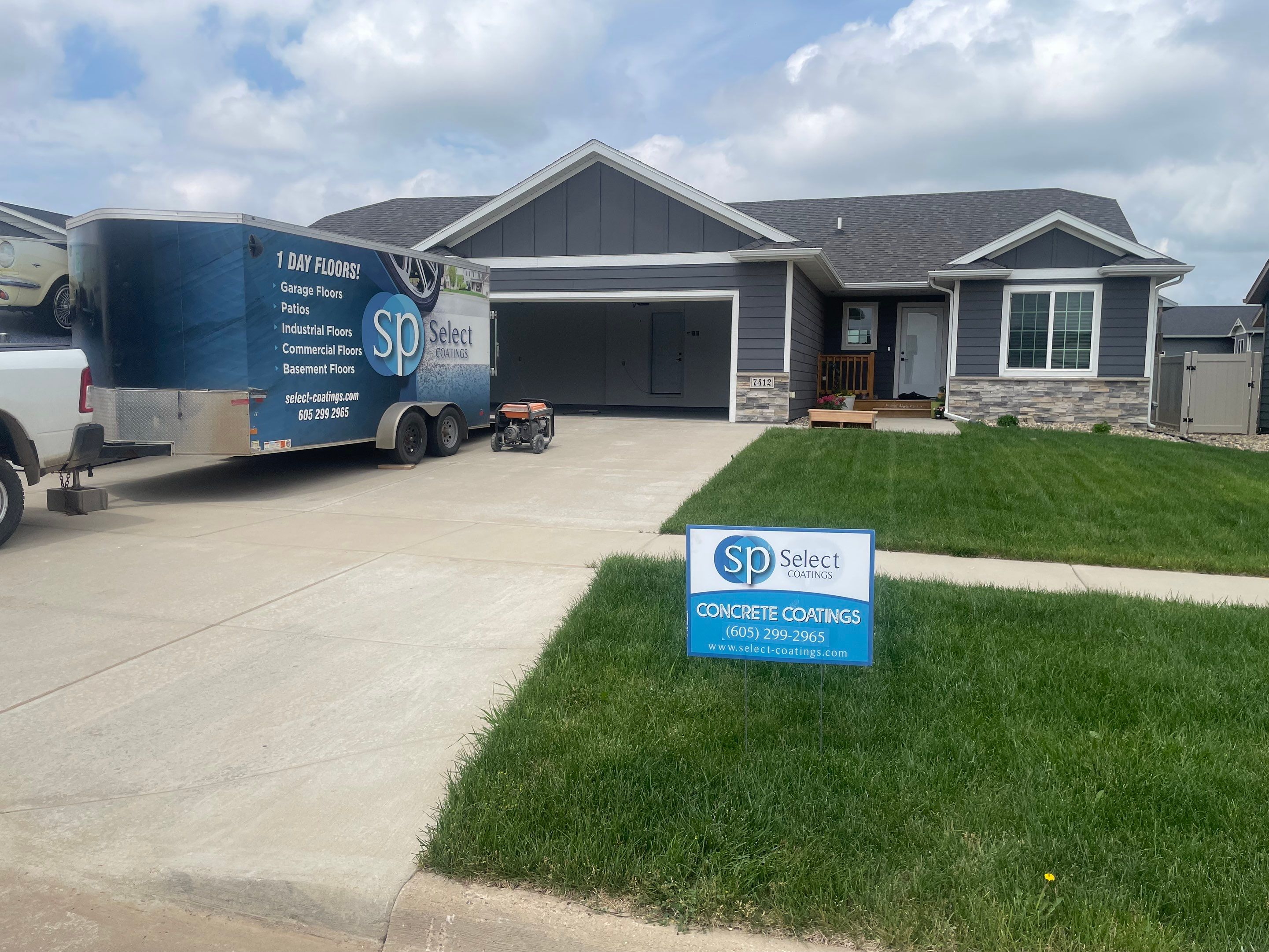 Grey Flake Epoxy Garage Floor Coating in Sioux Falls by Select Painting, Coatings & Garage Cabinets