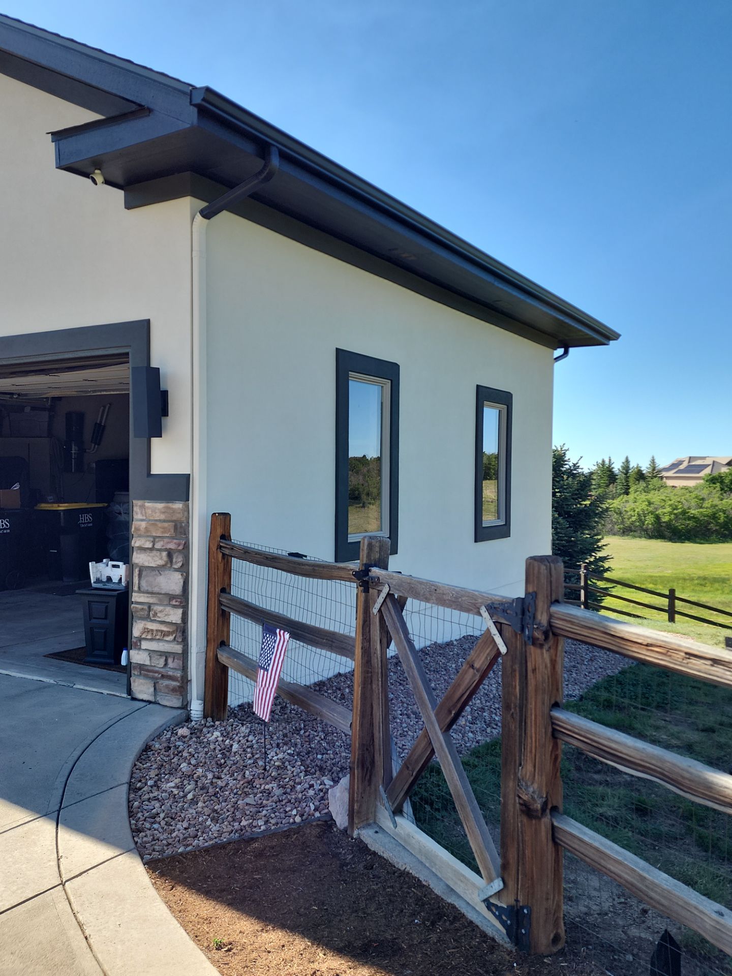 Castle Rock Elegance: White Stucco Exterior with Bold Tricorn Black by J&M Painting LLC