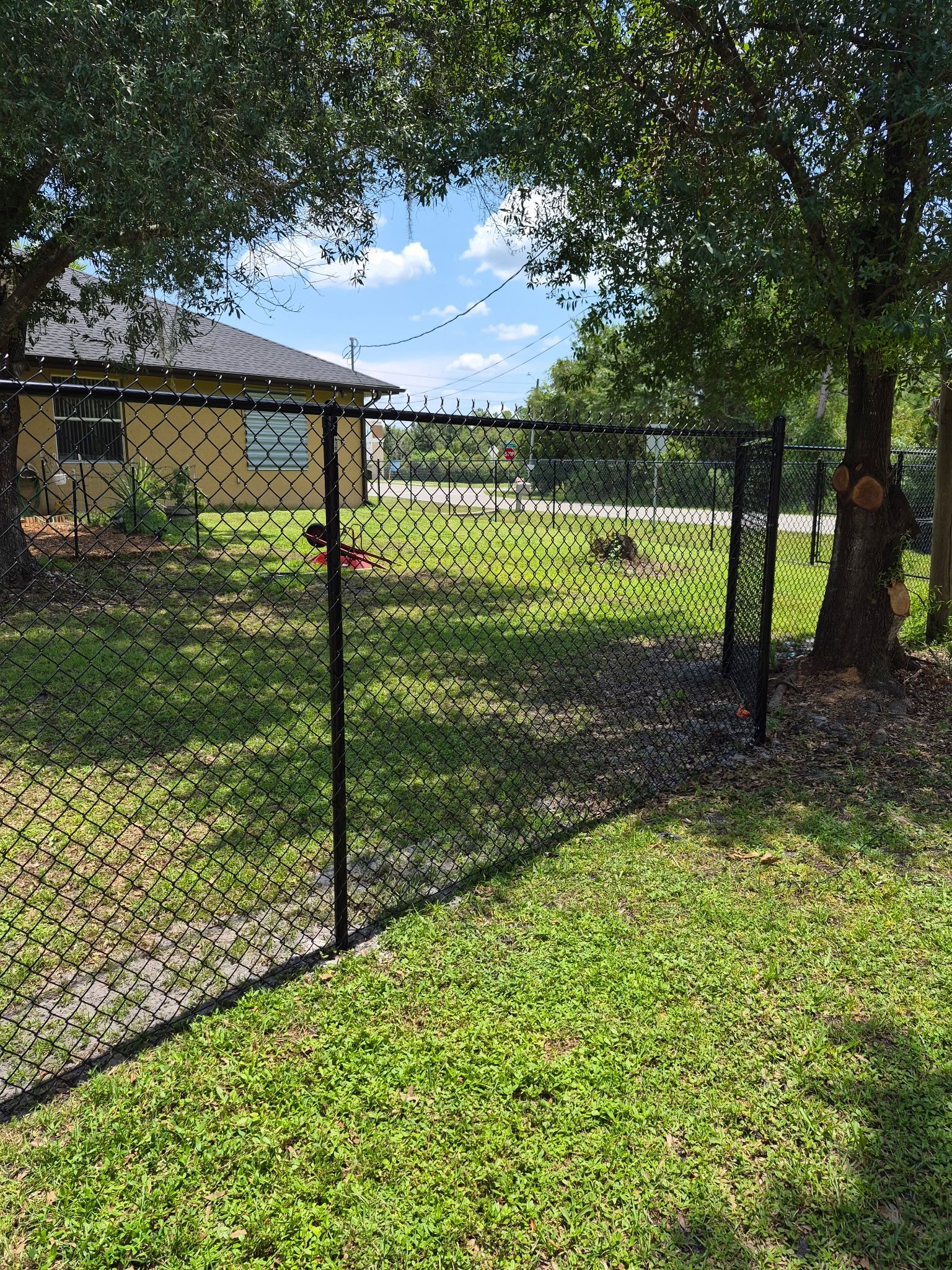 Black Chain Link Perimeter Fencing with Double Gates in Port Charlotte by True Fence LLC