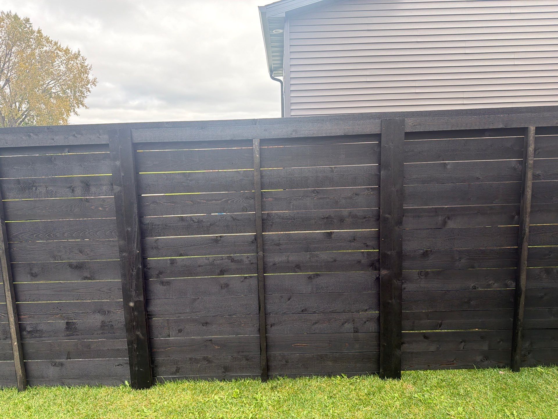 Modern Horizontal Wood Privacy Fence Installation in Cedar Falls by Perfect Picket Fence and Stain