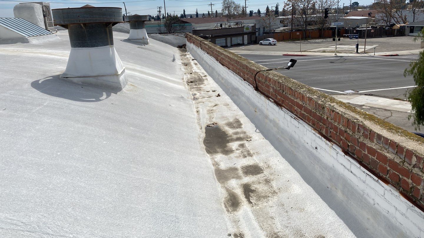 Polyurethane foam roof refurbish and recoating by Straight Edge Roofing Inc