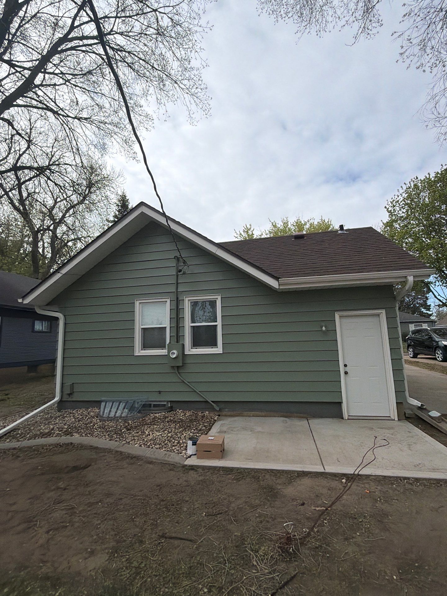 Exterior Siding Repair and Full House Repaint in Sioux Falls by Select Painting, Coatings & Garage Cabinets