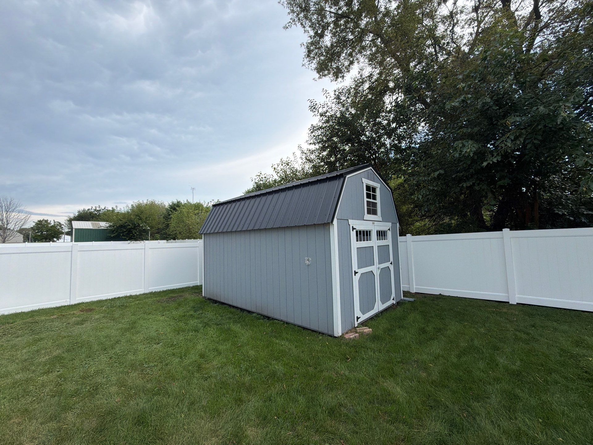 White Vinyl Privacy Fence Installation in Raymond, IA by Perfect Picket Fence and Stain