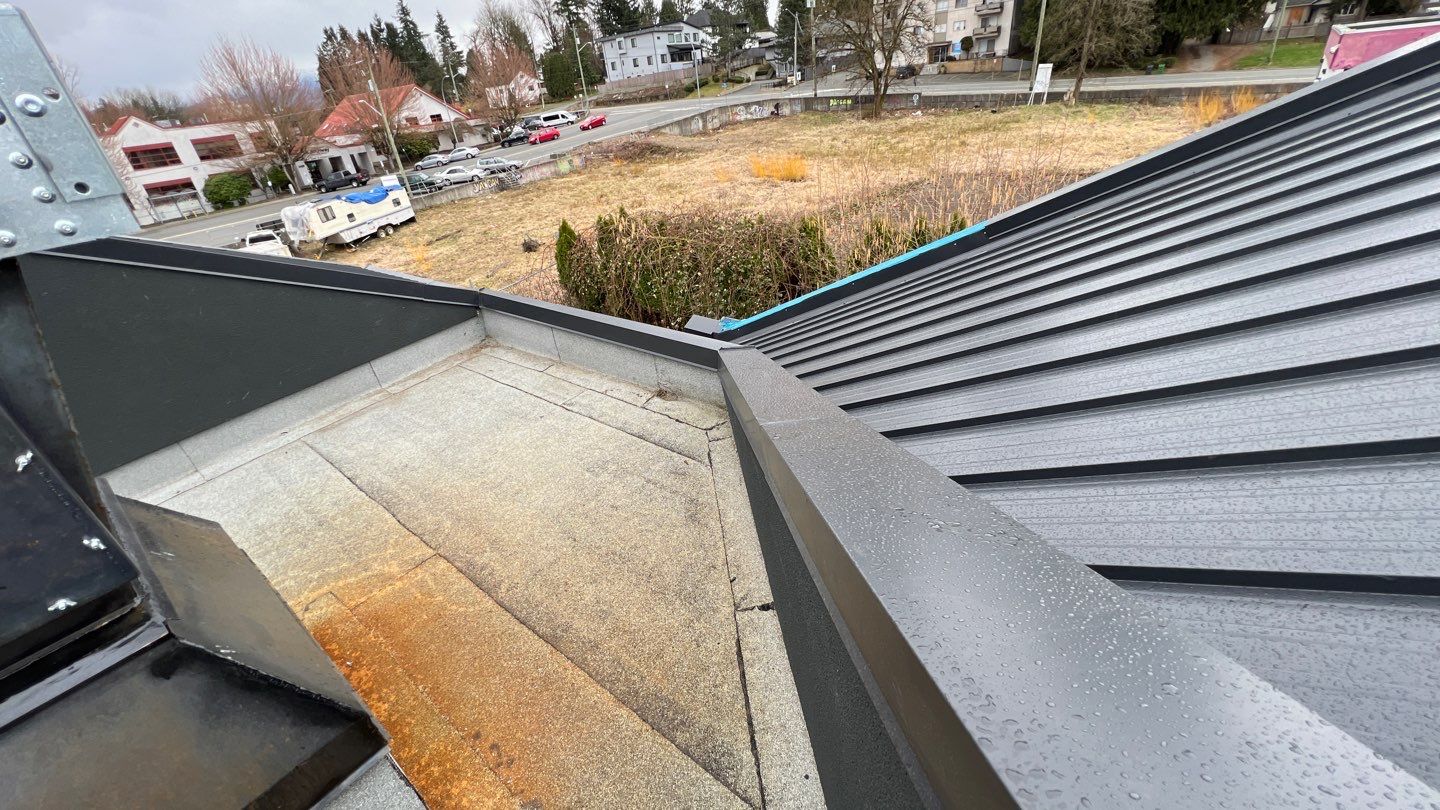 Commercial Roofing Installation using 12" Prolok metal and hidden gutters! by Top Notch Roofing Inc