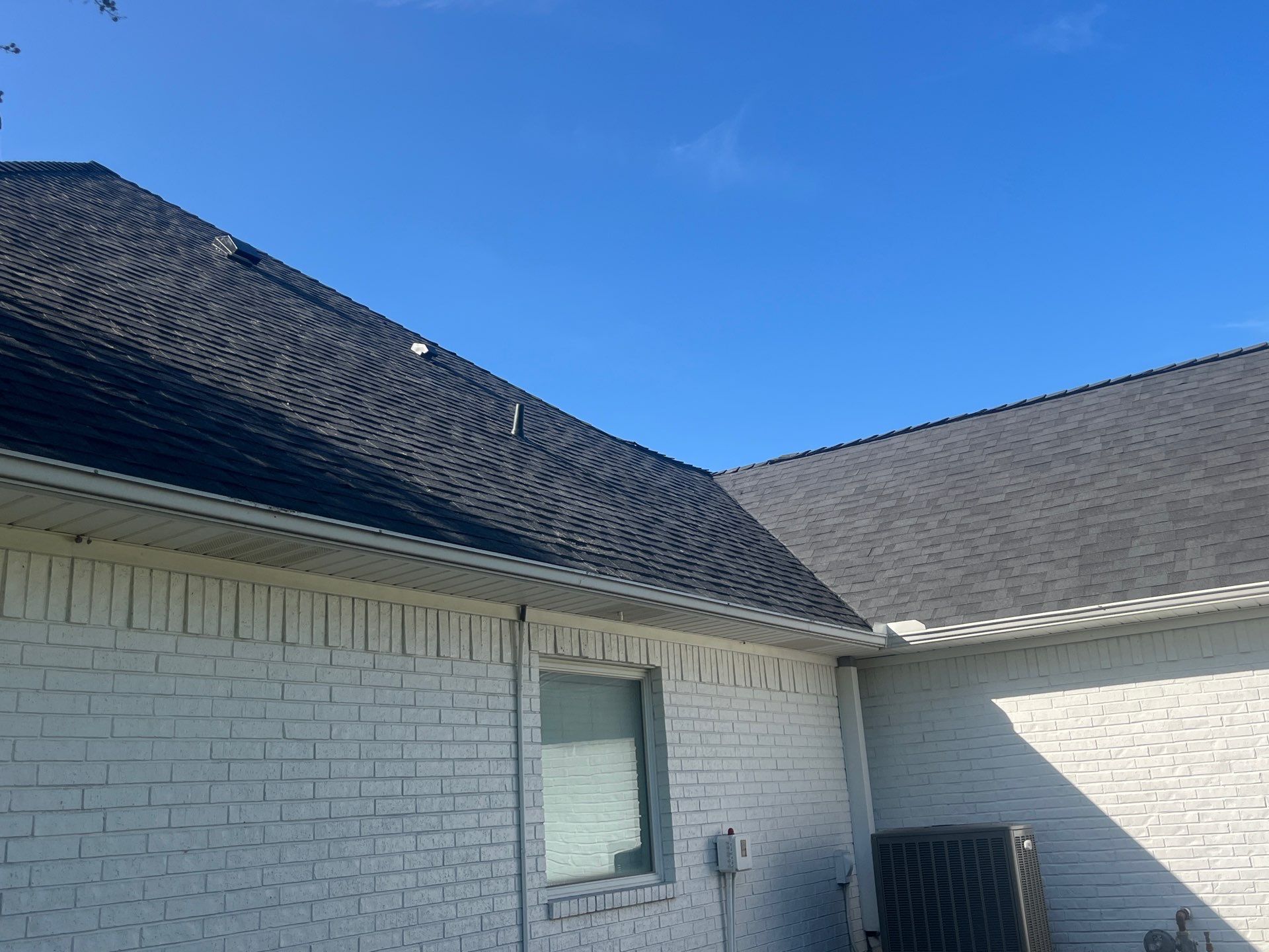 White brick with Malarkey Brilliant Black by Tejas Roofworks + Restoration