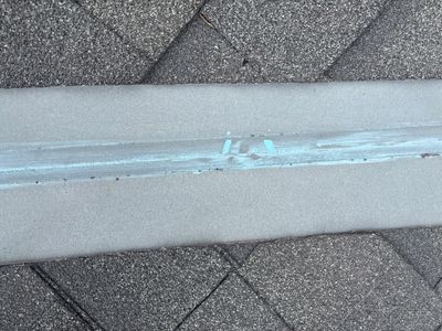 Close up of asphalt shingle roof with chalk markings