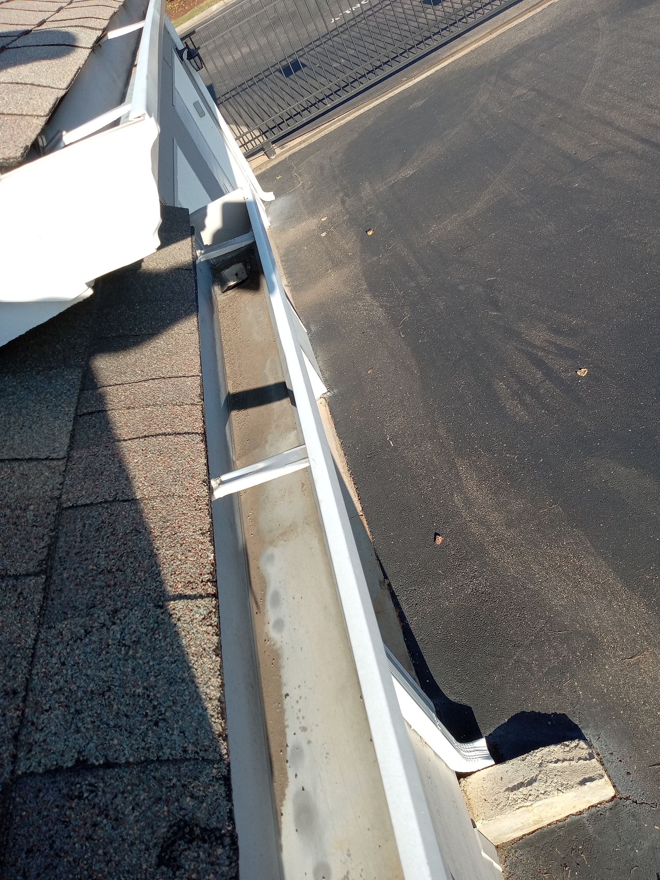 HOA gutter cleaning in Cumming & Forsyth County, GA after  photo showing full gutters.