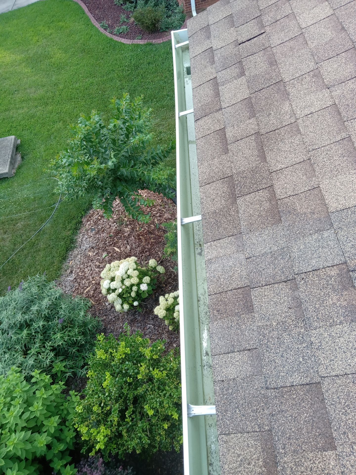 pressure washing gutter and roof cleaning to remove dirt buildup and ensure proper drainage