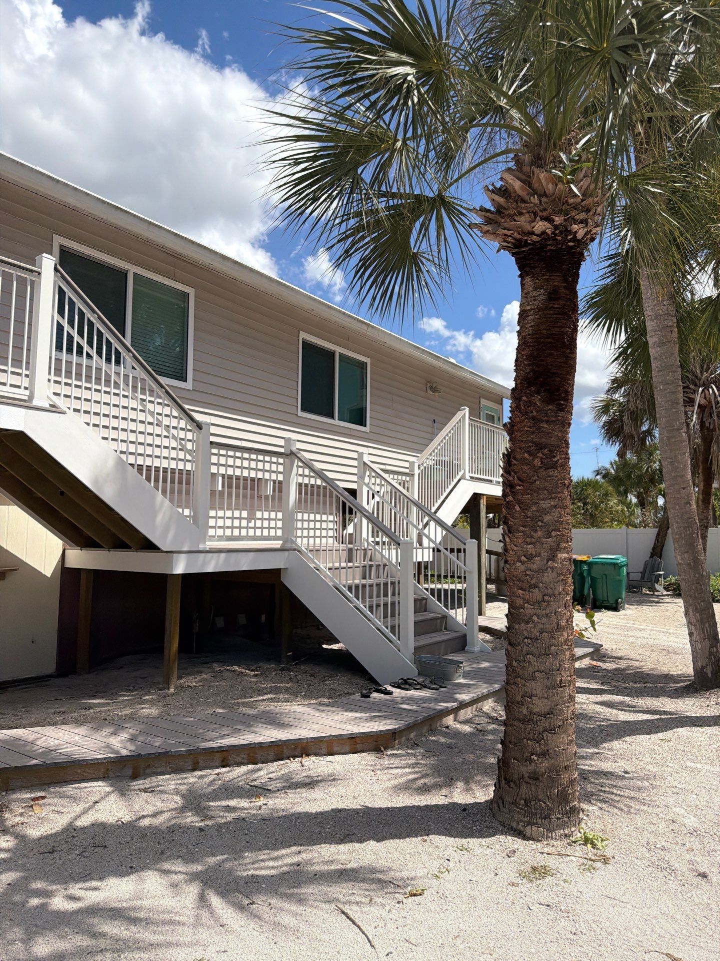 Elevated Home Deck Reconstruction With White Aluminum Railings in Placida by Smirnov Construction Inc