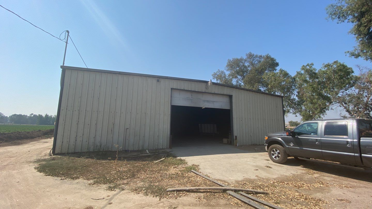 Spray foam insulation on inside of metal industrial building by Straight Edge Roofing Inc