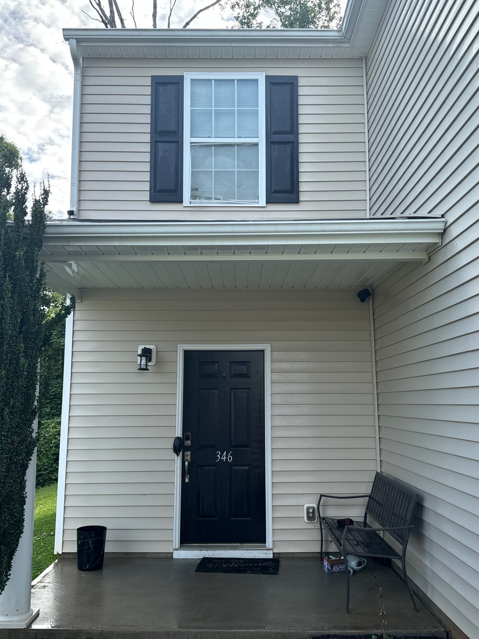 the service shown is cleaning the siding and entryway of a home eliminating dirt and grime for improved appearance