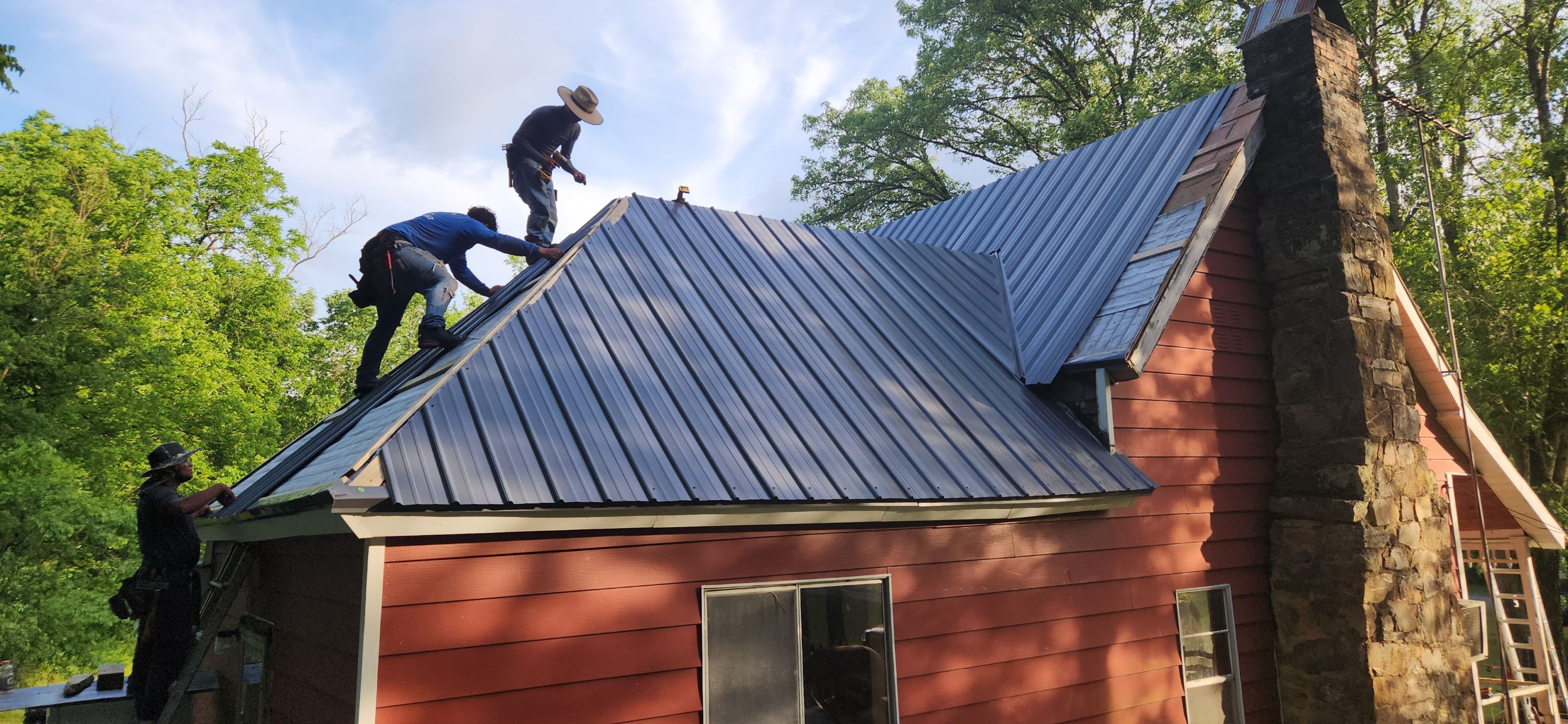 Residential Roofing Installation using 26 Gauge Colored Panels by Hostetler Roofing