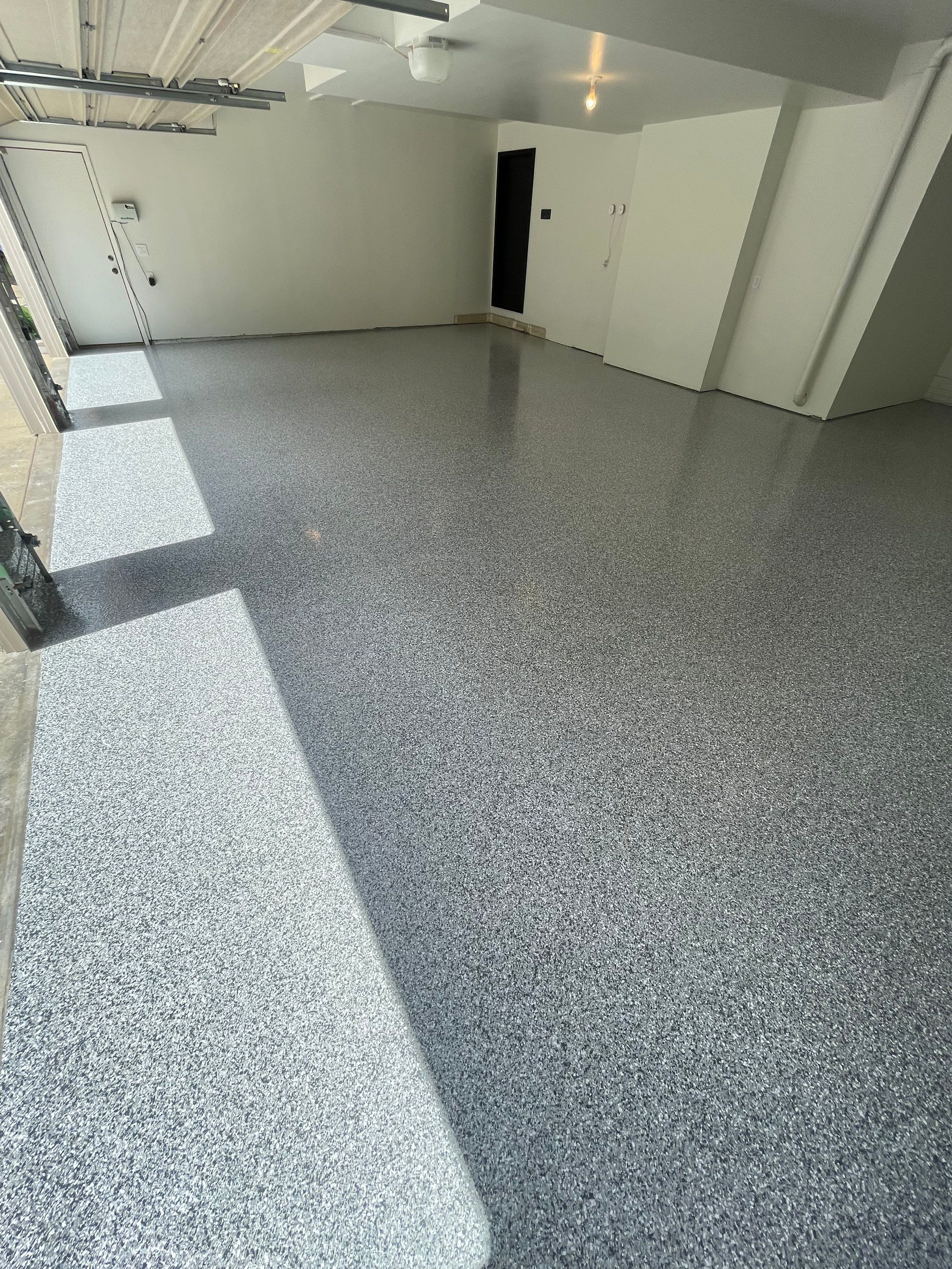 Gray Speckled Epoxy Garage Floor Coating in Sioux Falls by Select Painting, Coatings & Garage Cabinets