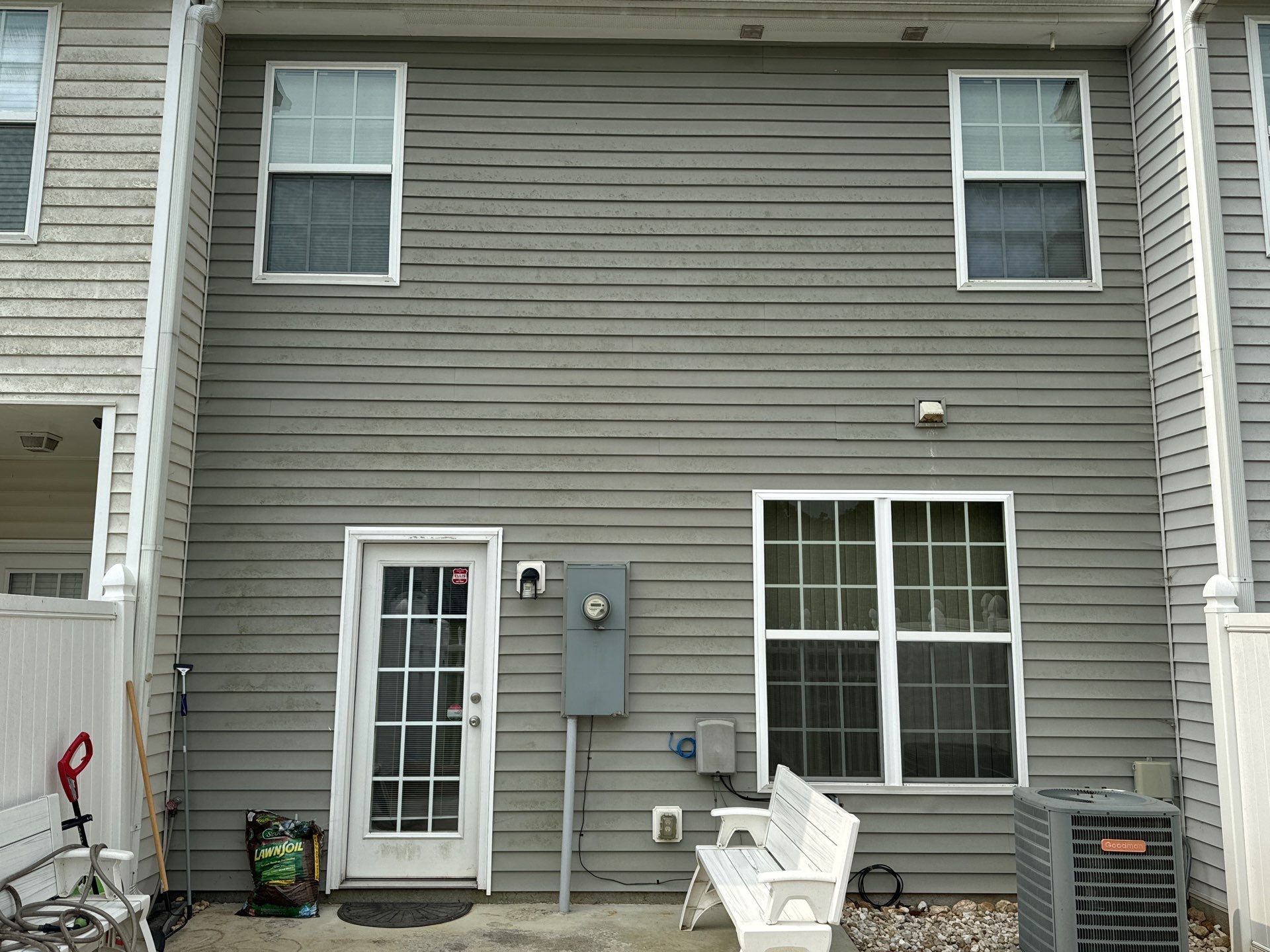 pressure washing exterior siding windows and doors to remove dirt and grime