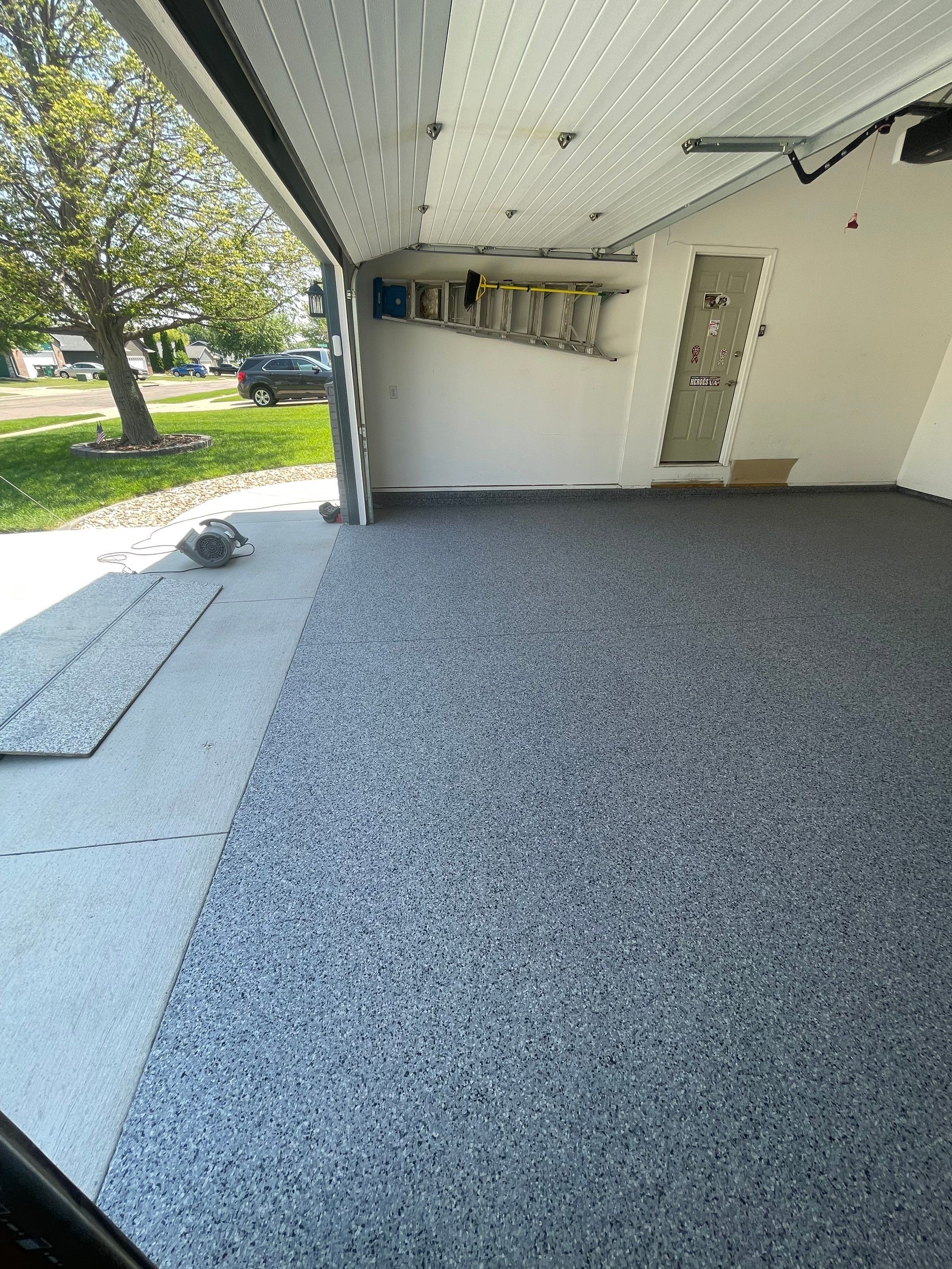Sioux Falls Garage Floor Coating with Nightfall Decorative Chips by Select Painting, Coatings & Garage Cabinets
