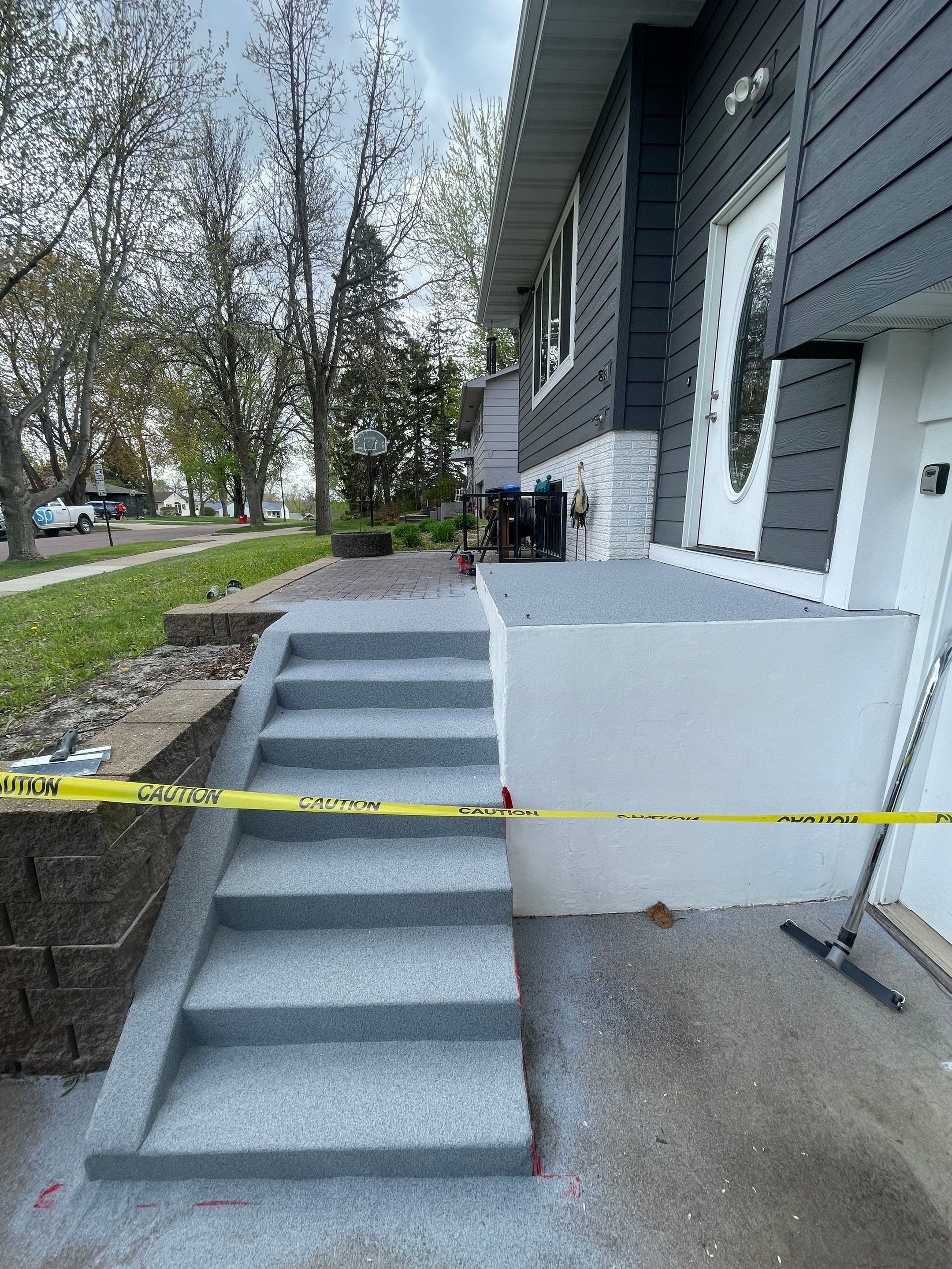 Grey Polyaspartic Porch and Stair Resurfacing in Sioux Falls by Select Painting, Coatings & Garage Cabinets