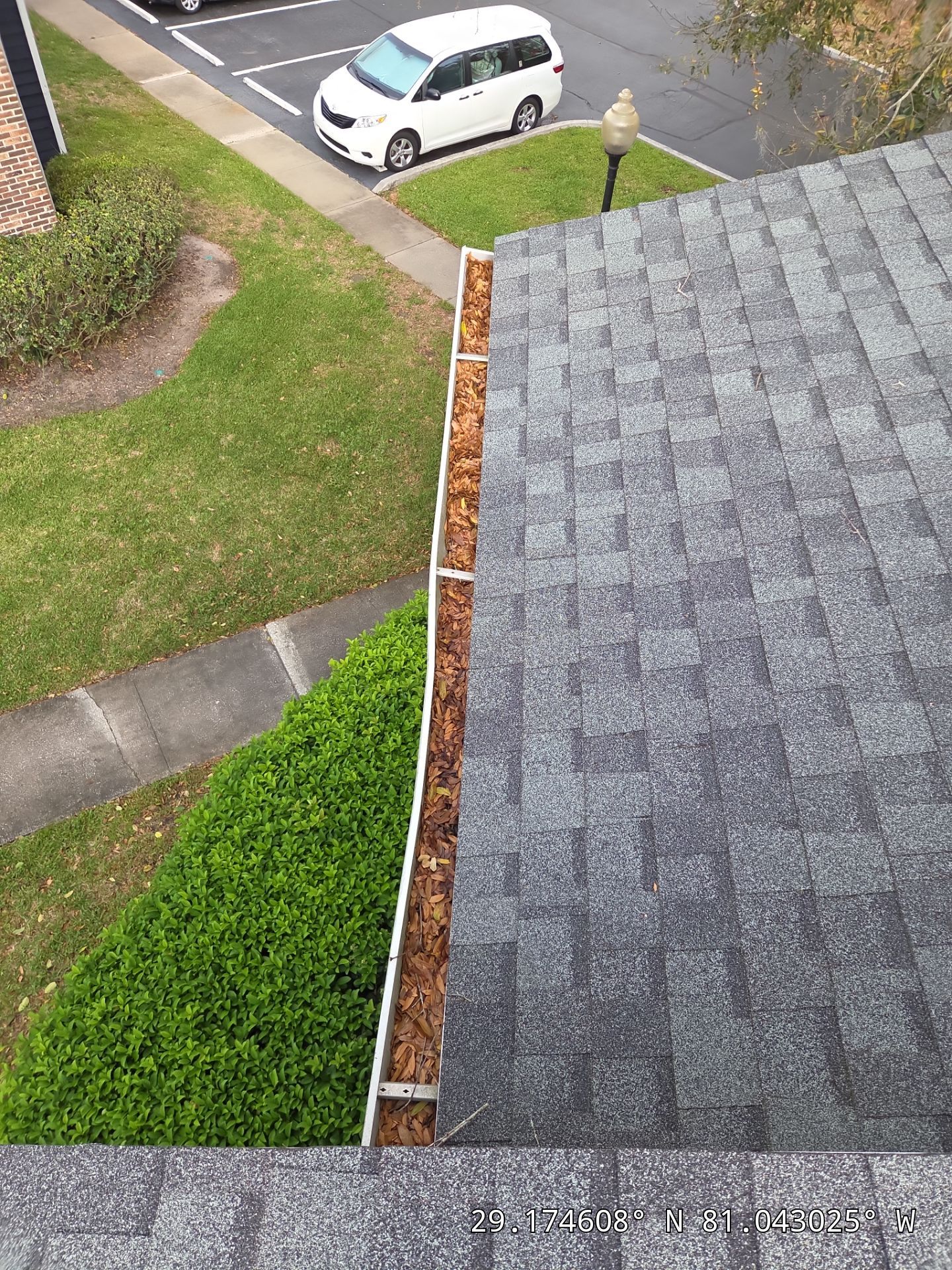 Commercial gutter cleaning Daytona Beach before photo with filled gutters