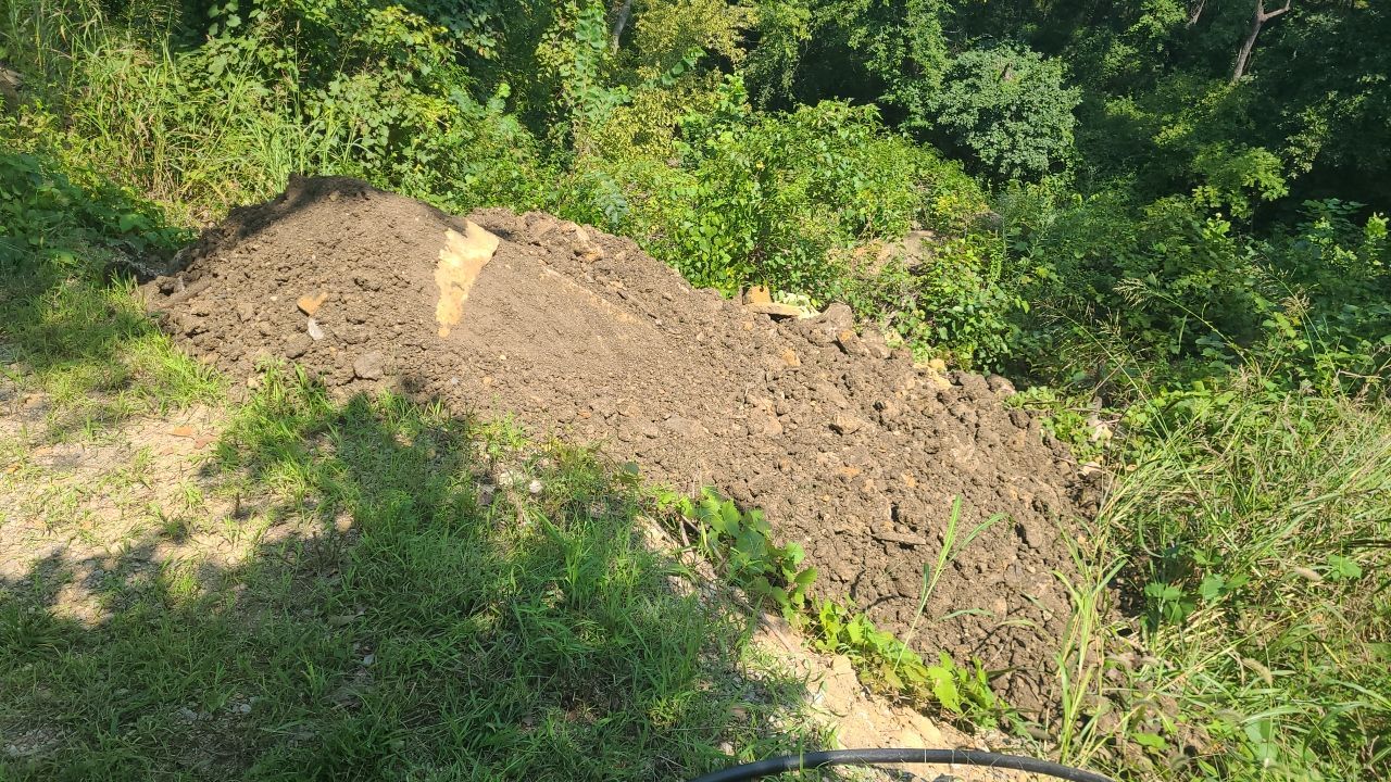 Supporting back of home with backfill at edge of steep creek by LAND ESCAPES LLC