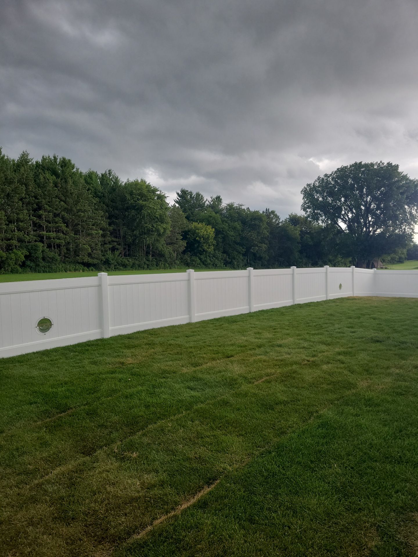 White Vinyl Privacy Fence With Pet Window in Cedar Falls by Perfect Picket Fence and Stain