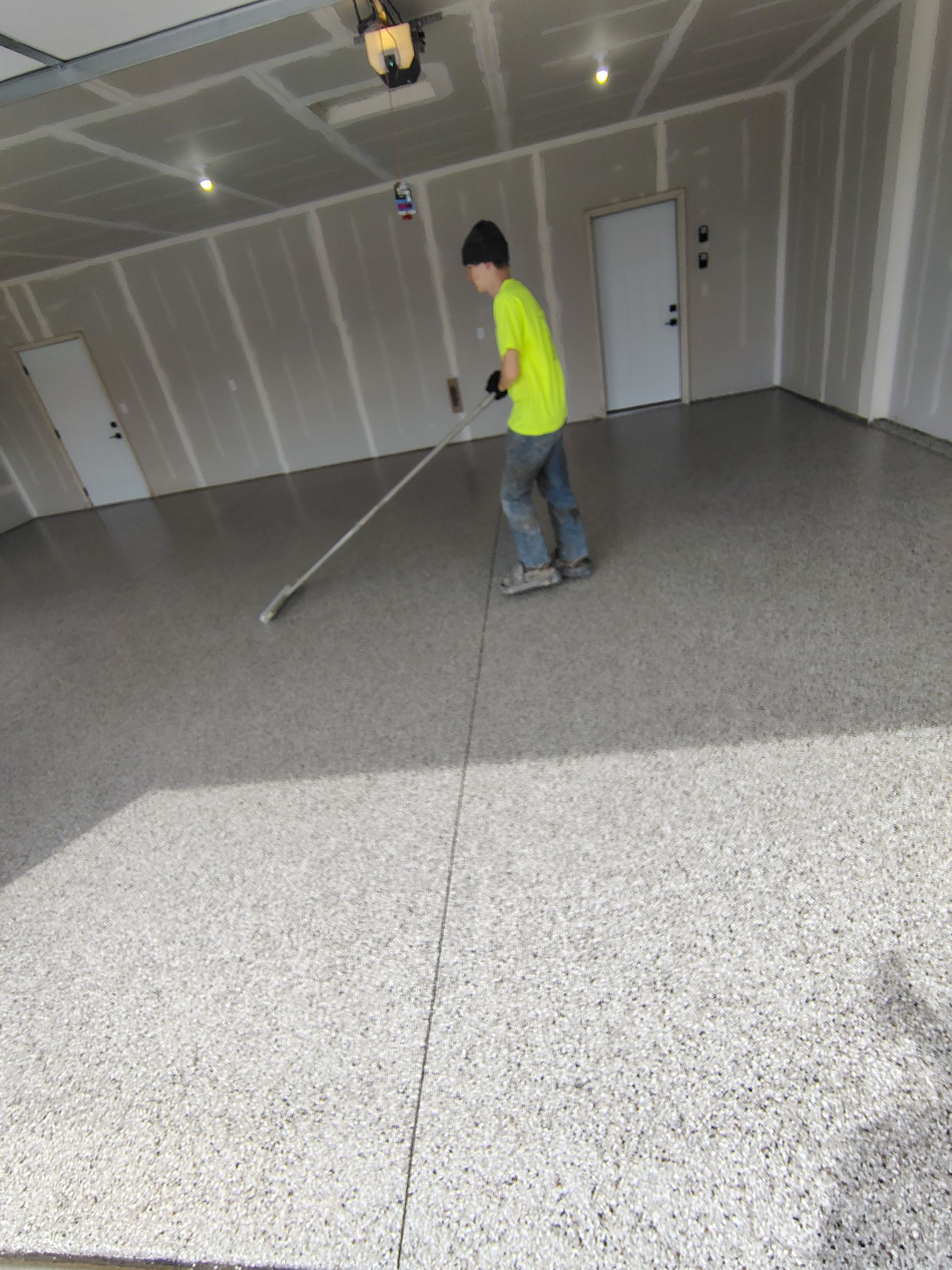 Speckled Epoxy Garage Floor Coating Installation in Sioux Falls by Select Painting, Coatings & Garage Cabinets