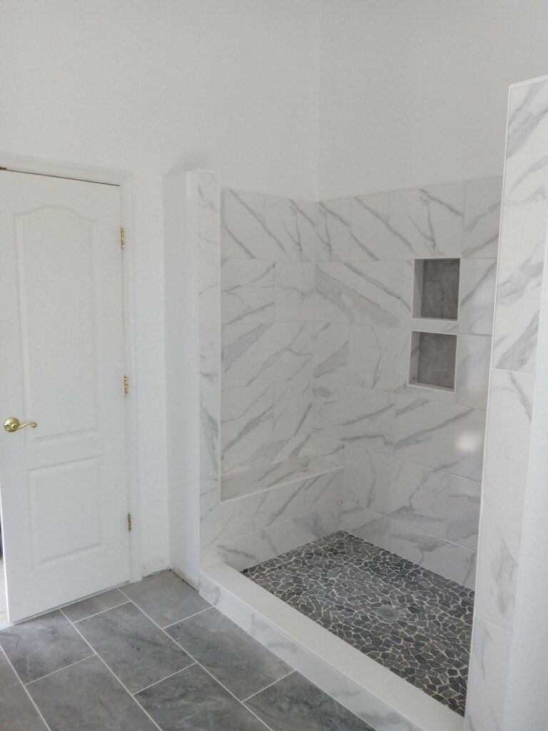 Bathroom Remodel using porcelain tiles , wood make vanetys , mirross , bathroom accessories  by Jesus Master Handyman LLC 