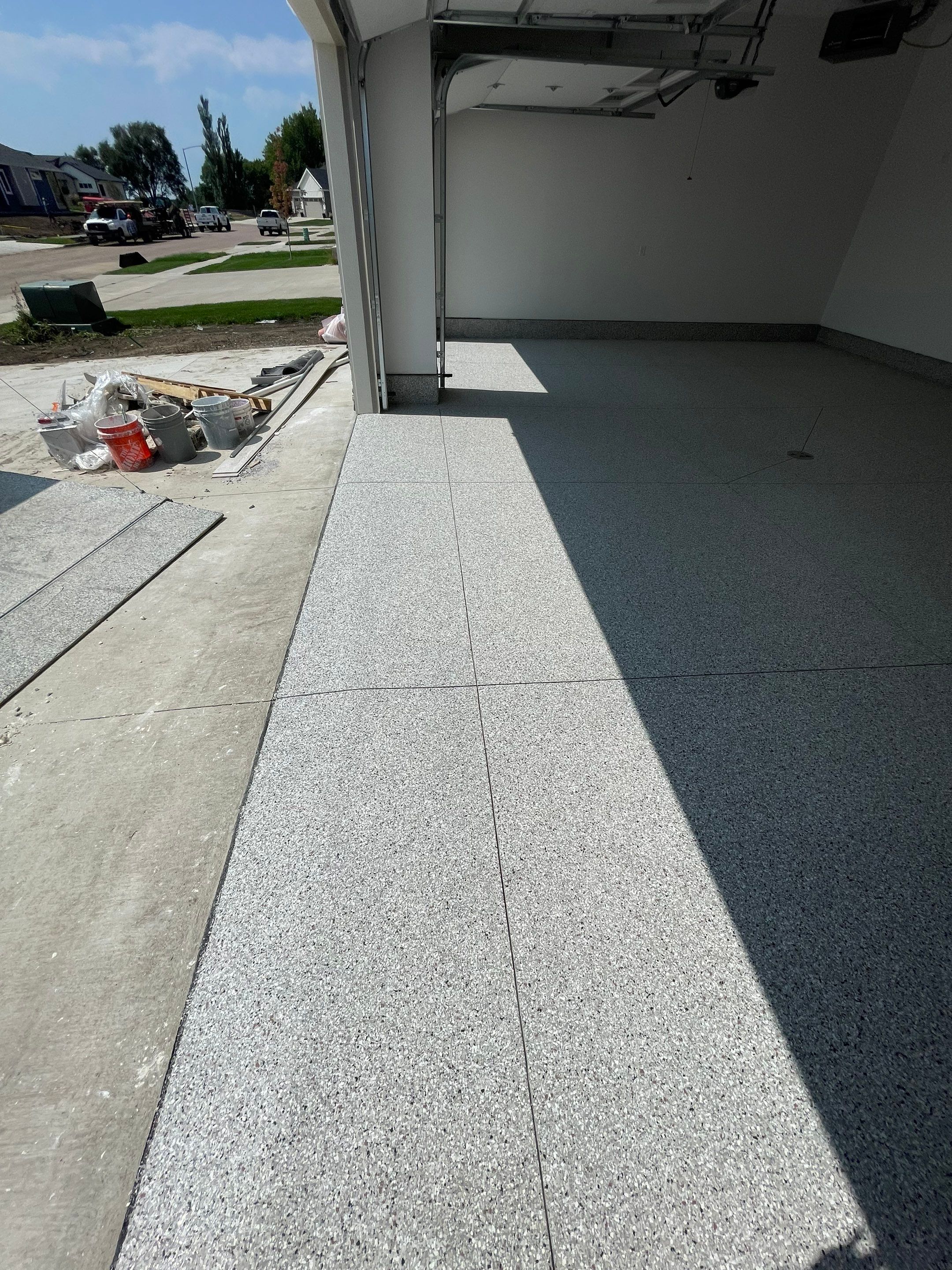 Grey Speckled Garage Floor Coating in Sioux Falls by Select Painting, Coatings & Garage Cabinets