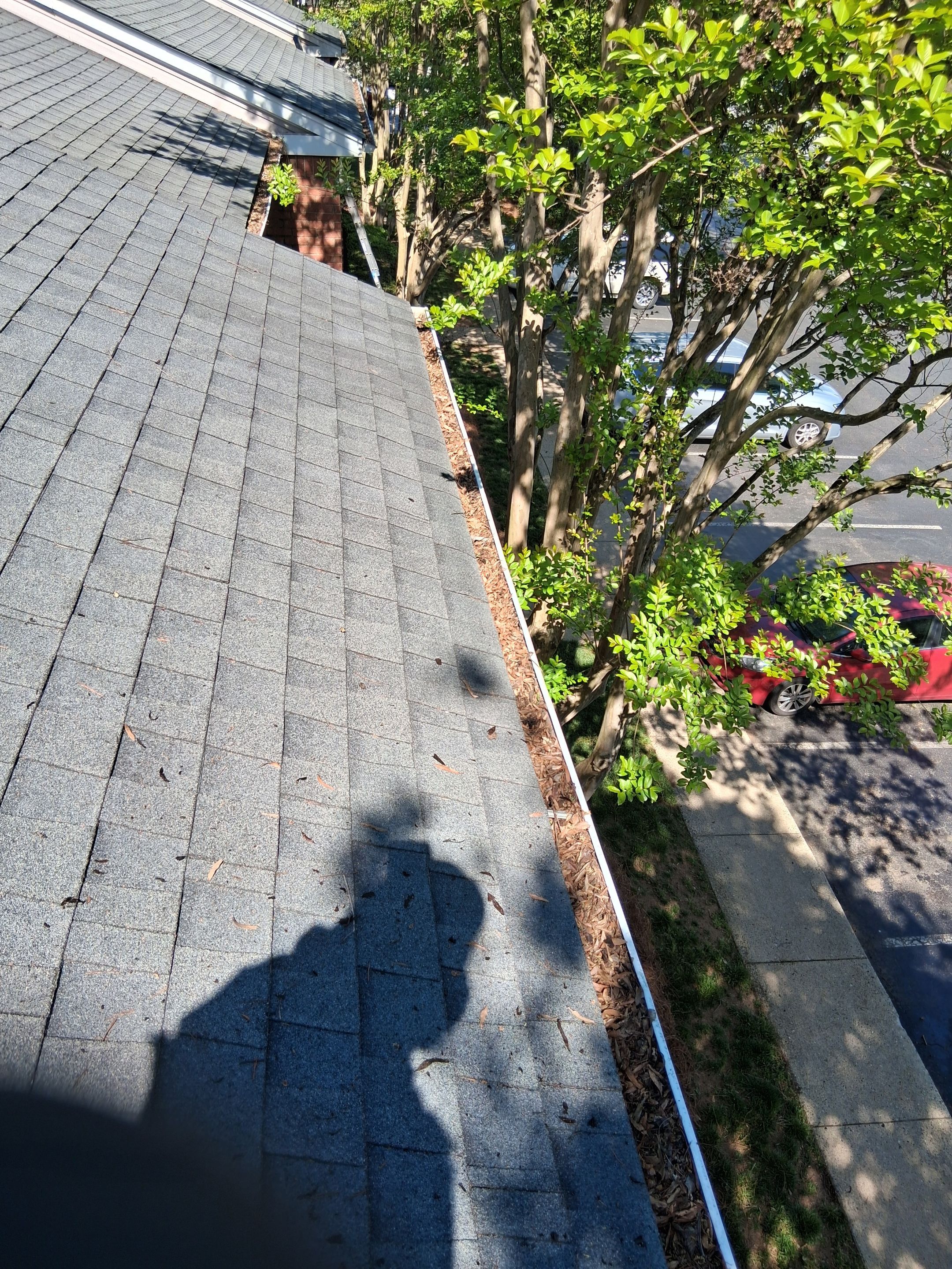 HOA gutter cleaning in Mooresville & Lake Norman, NC, before  photo showing full gutters.