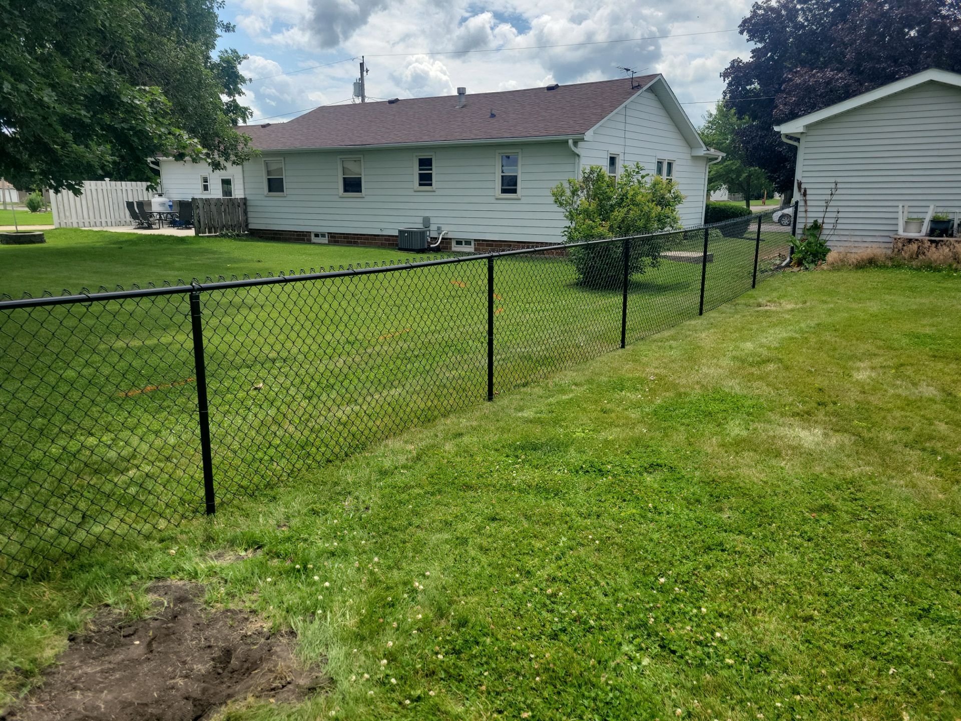Residential Black Vinyl-Coated Chain Link Fence Installation in Allison by Perfect Picket Fence and Stain