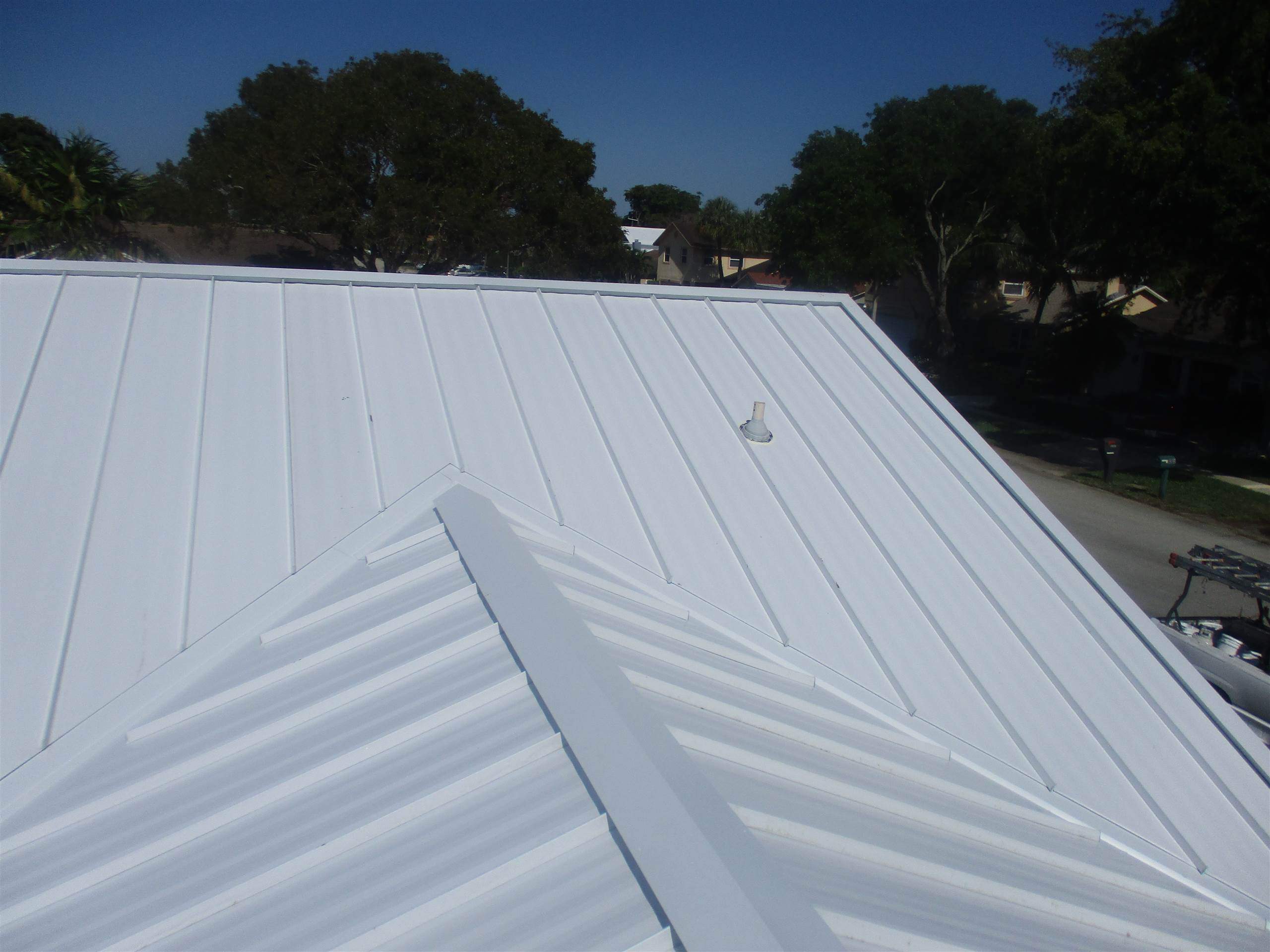 Standing Seam Metal & Flat Re-Roof using 1.5" Nail Strip 24ga Solar White Kynar Coated Standing Seam Metal Panels by Morton Roofing, Inc.