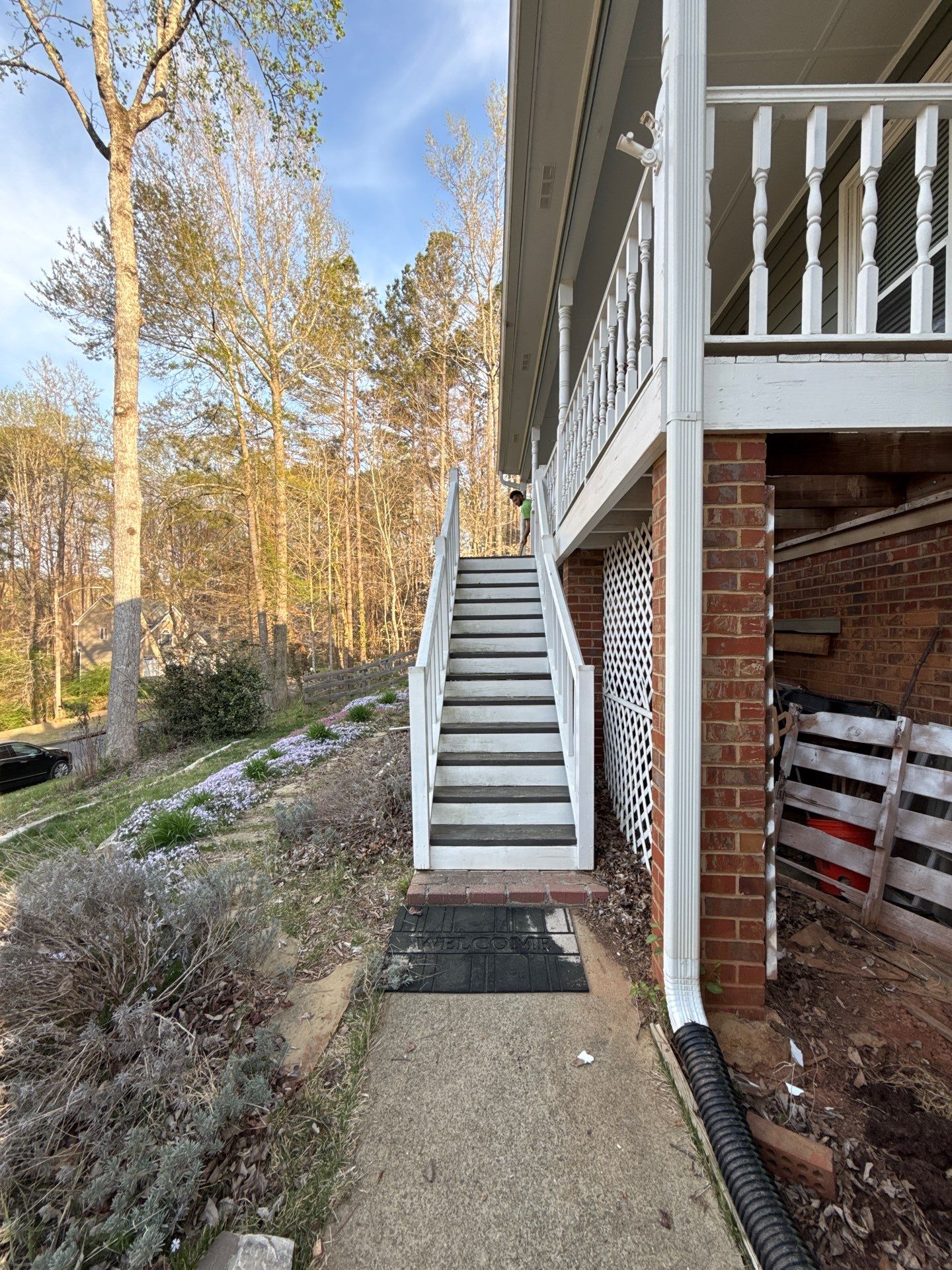 Composite Deck and Porch Renovation With Black Metal Railings by Swift Home Renovations 