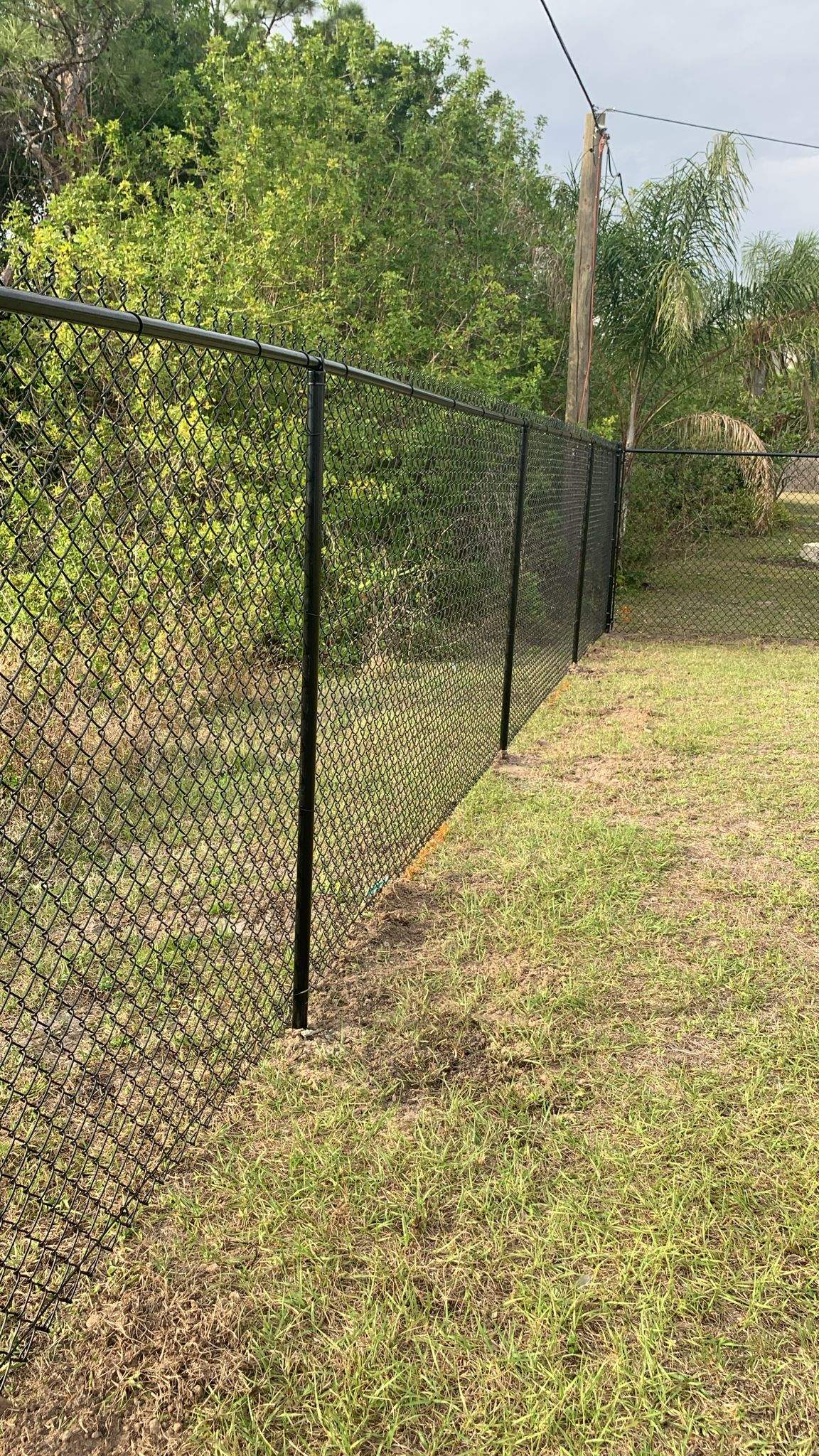 Black Vinyl-Coated Chain-Link Fence Installation in Port Charlotte by True Fence LLC