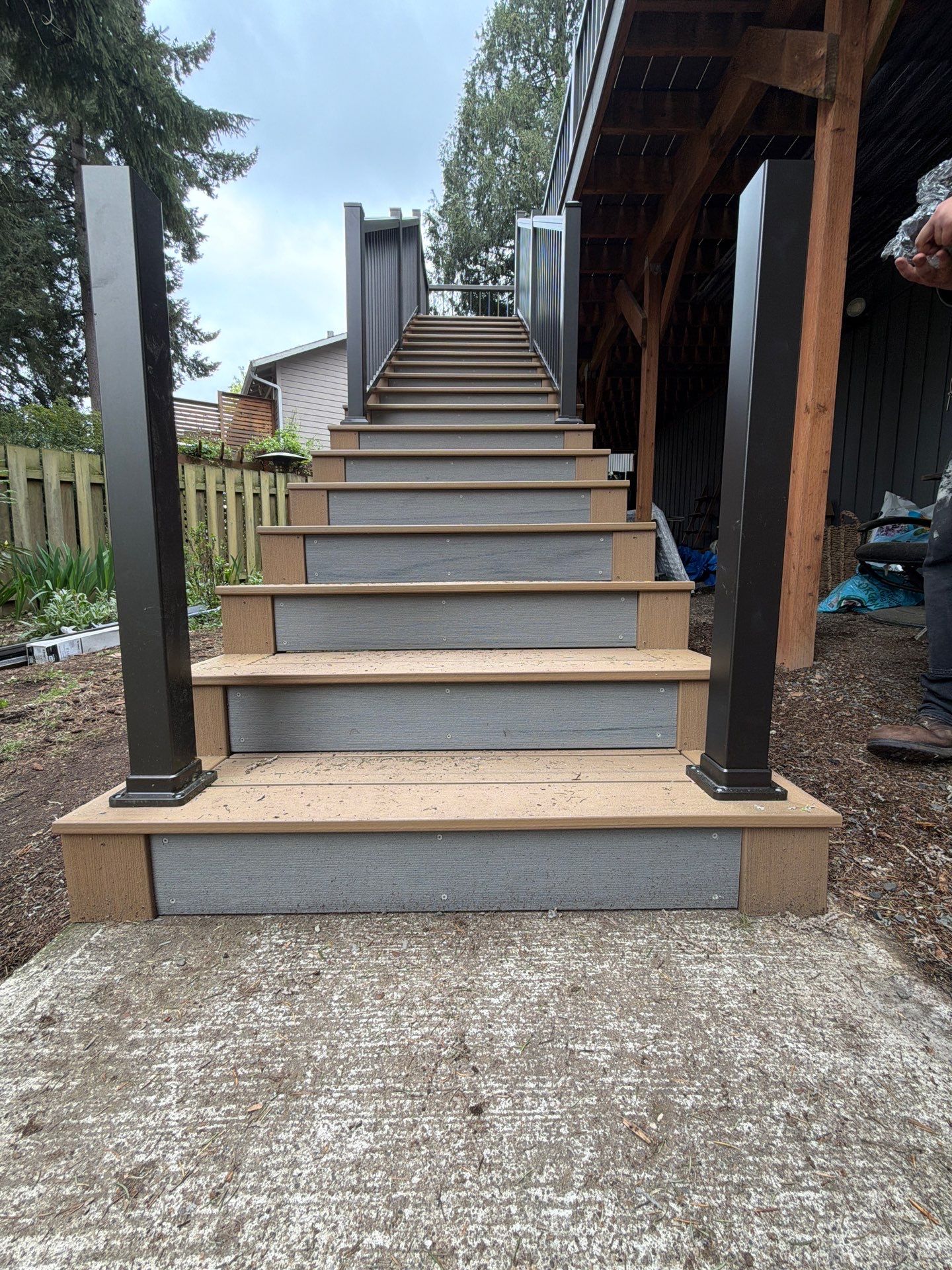 Elevated TimberTech Composite Deck Replacement With Black Metal Railings by Emerald City Energy
