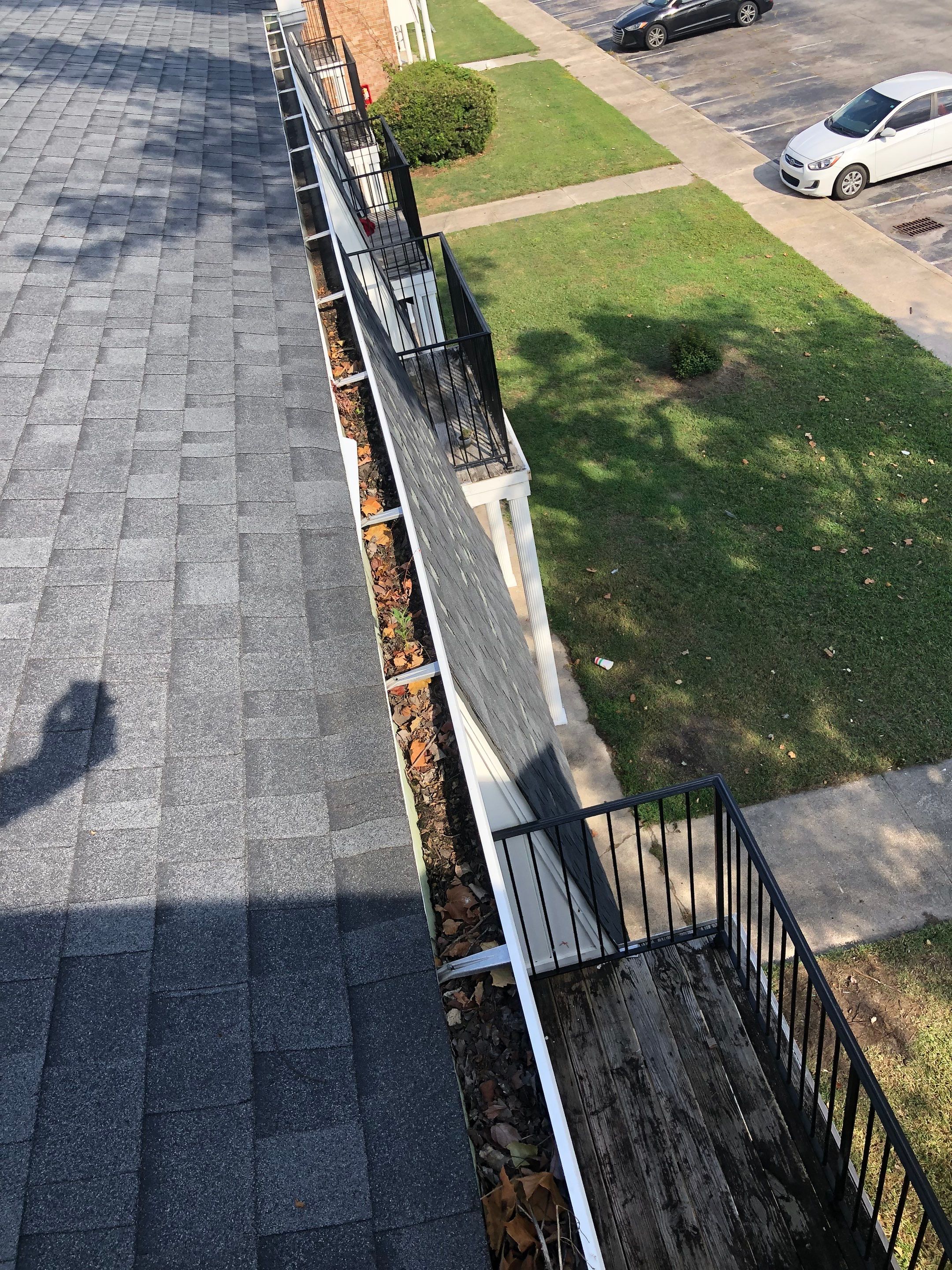 Commercial gutter cleaning Jacksonville, NC before photo with filled gutters