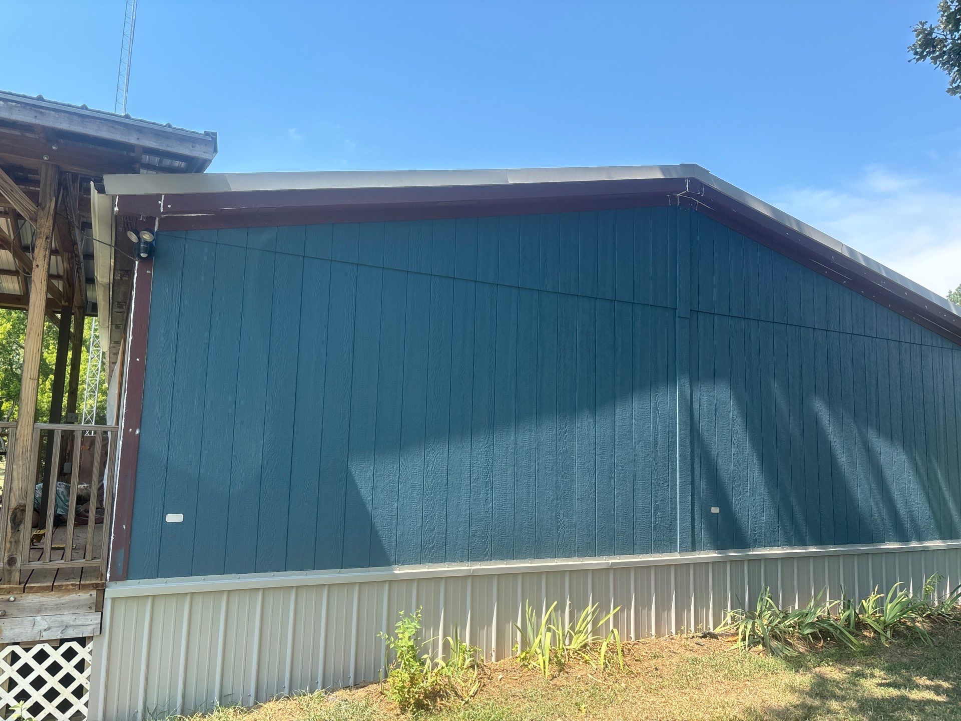 Exterior Painting in Fruitvale, TX | Wood Porch & Home in Deep Navy Blue by Quality Coats Painting