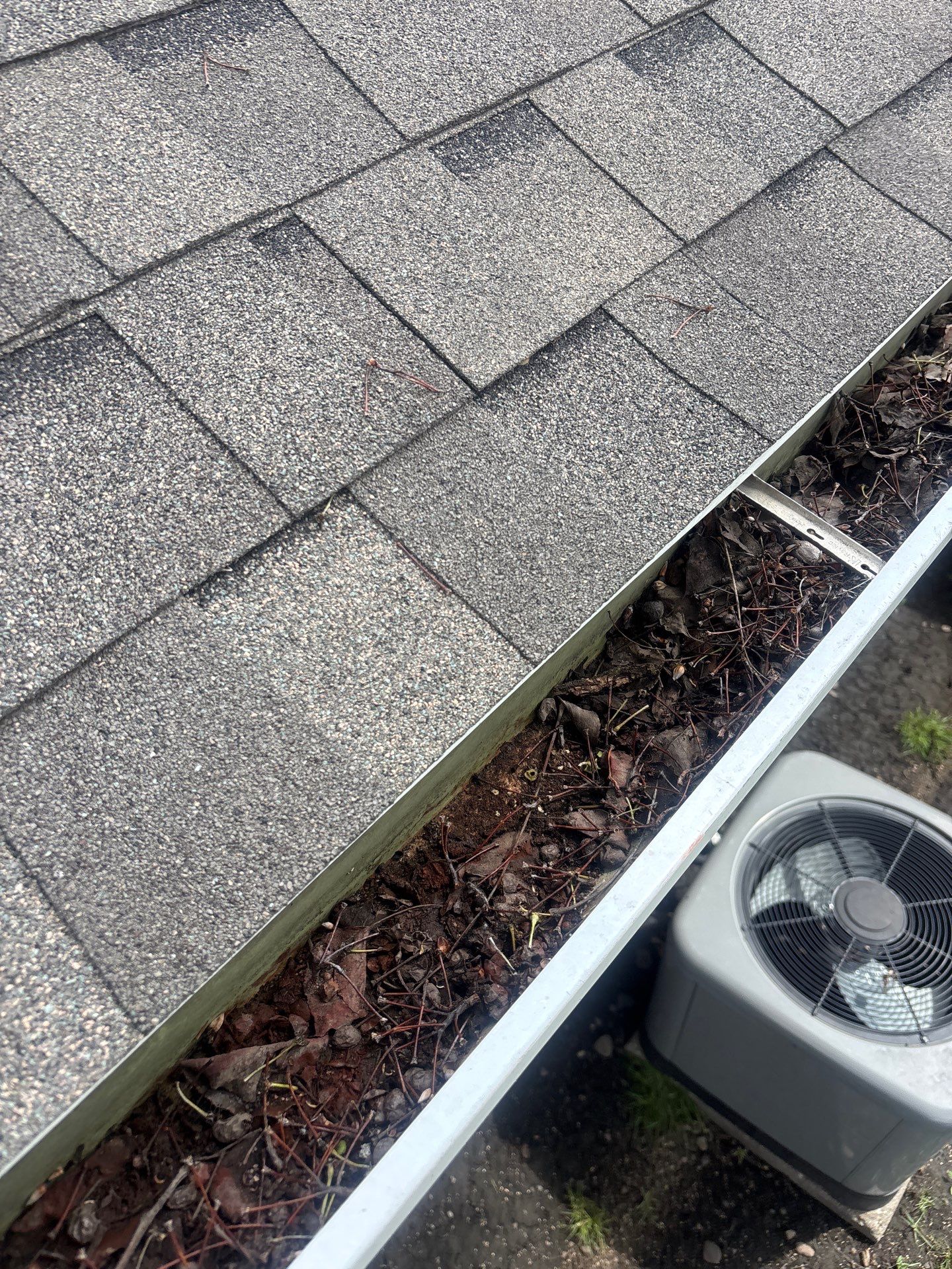 Commercial gutter cleaning Ames, IA before photo with filled gutters