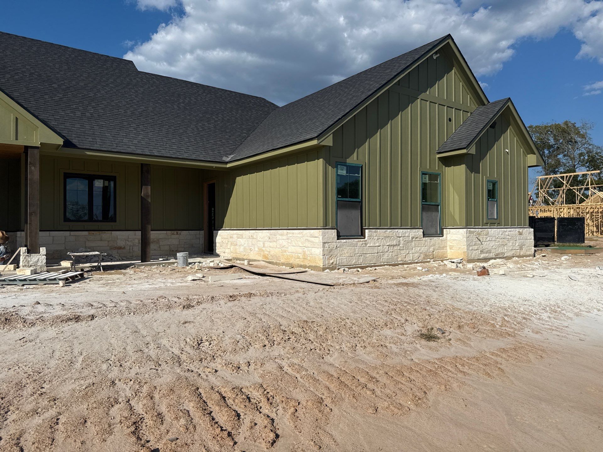 Cleveland Ranch Charm: Natural Stone Wainscot with Green Accent Siding. by Apex Conventional Stucco Llc