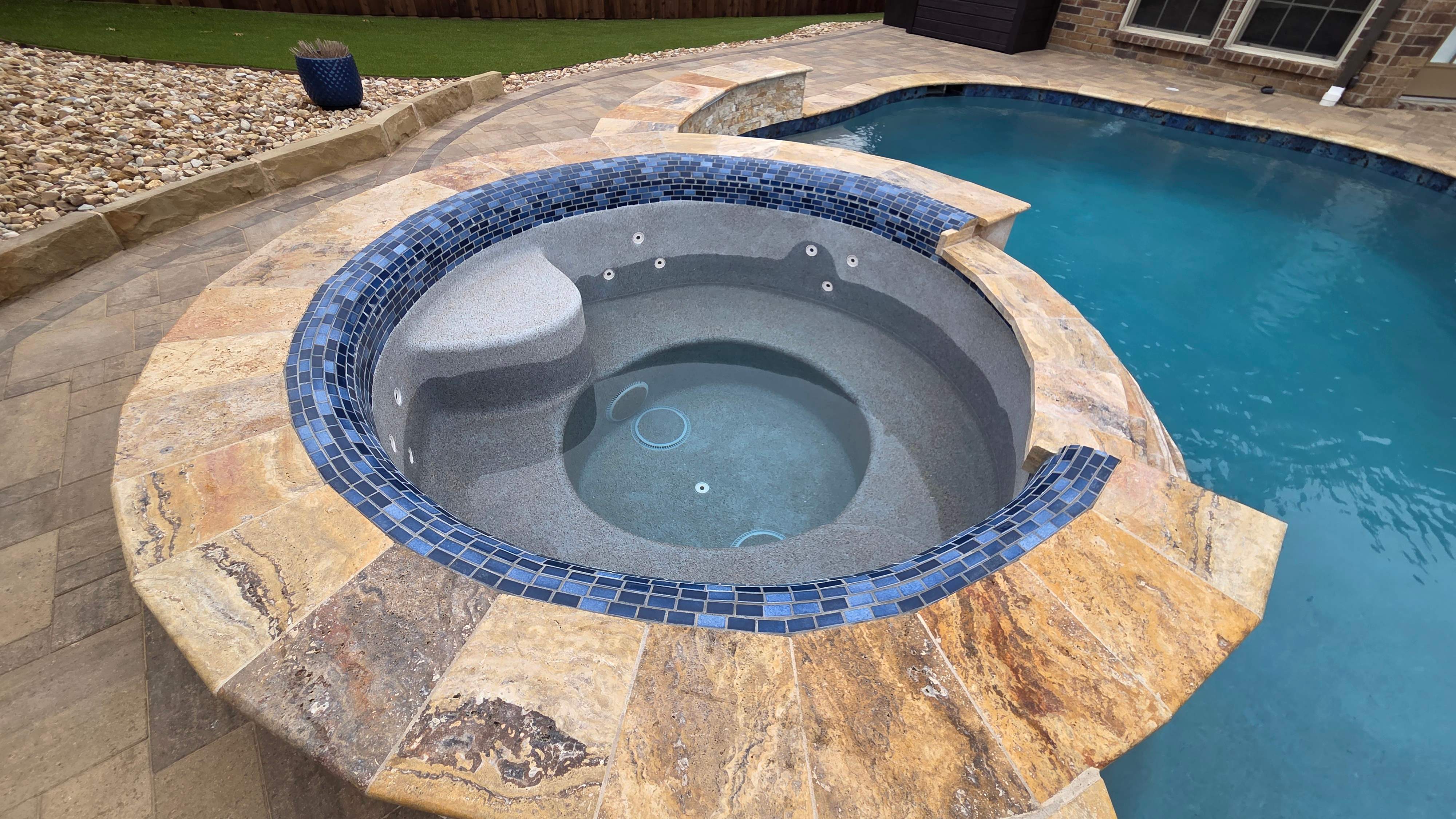 Freeform Pool with Raised Stone Spa by Pinnacle Pools and Spas - DFW