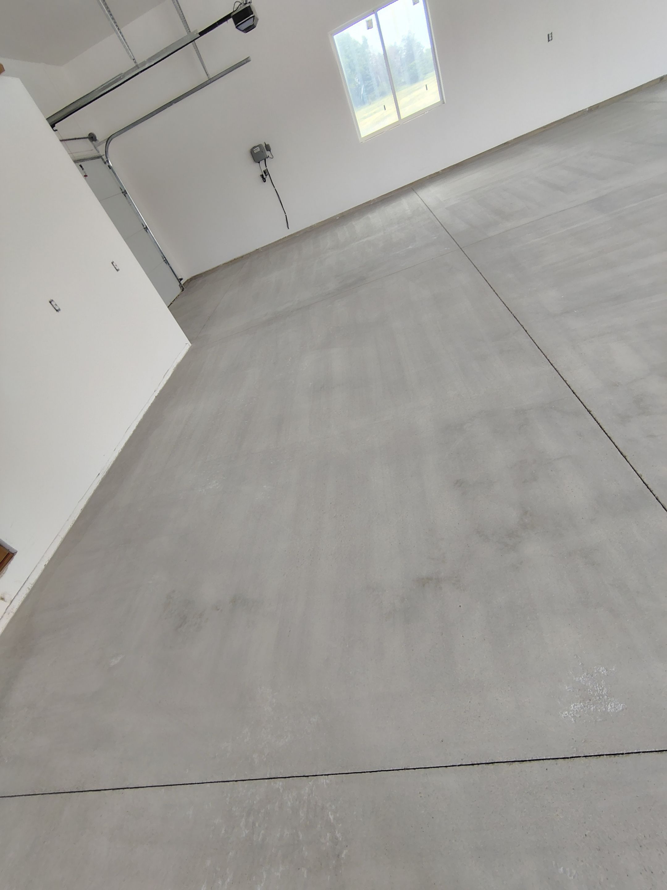Multi-Bay Garage Concrete Coating and Floor Refinishing in South Dakota by Select Painting, Coatings & Garage Cabinets