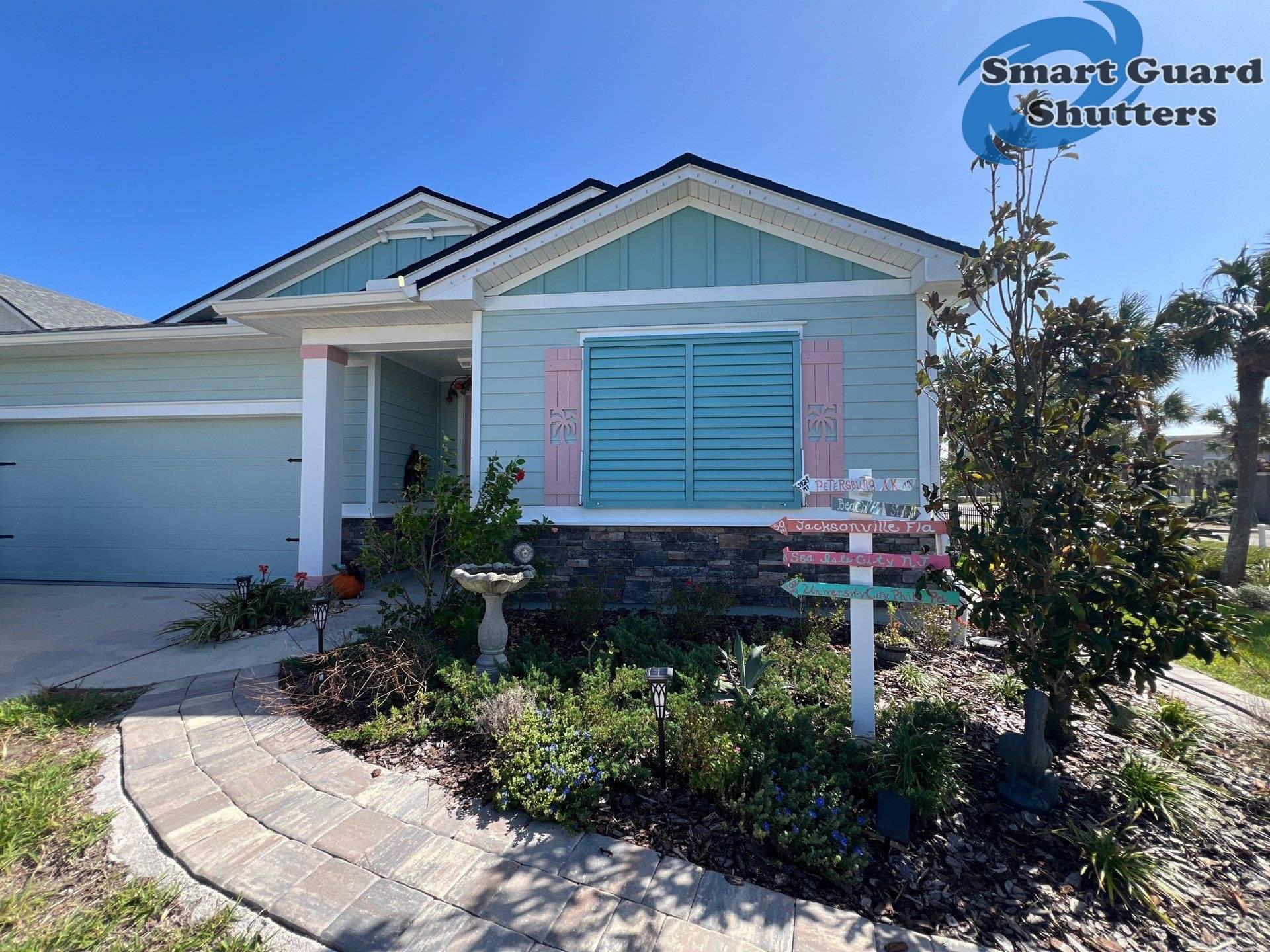 Impact Bahama Shutters in Pastel Turquoise by Smart Guard Shutters
