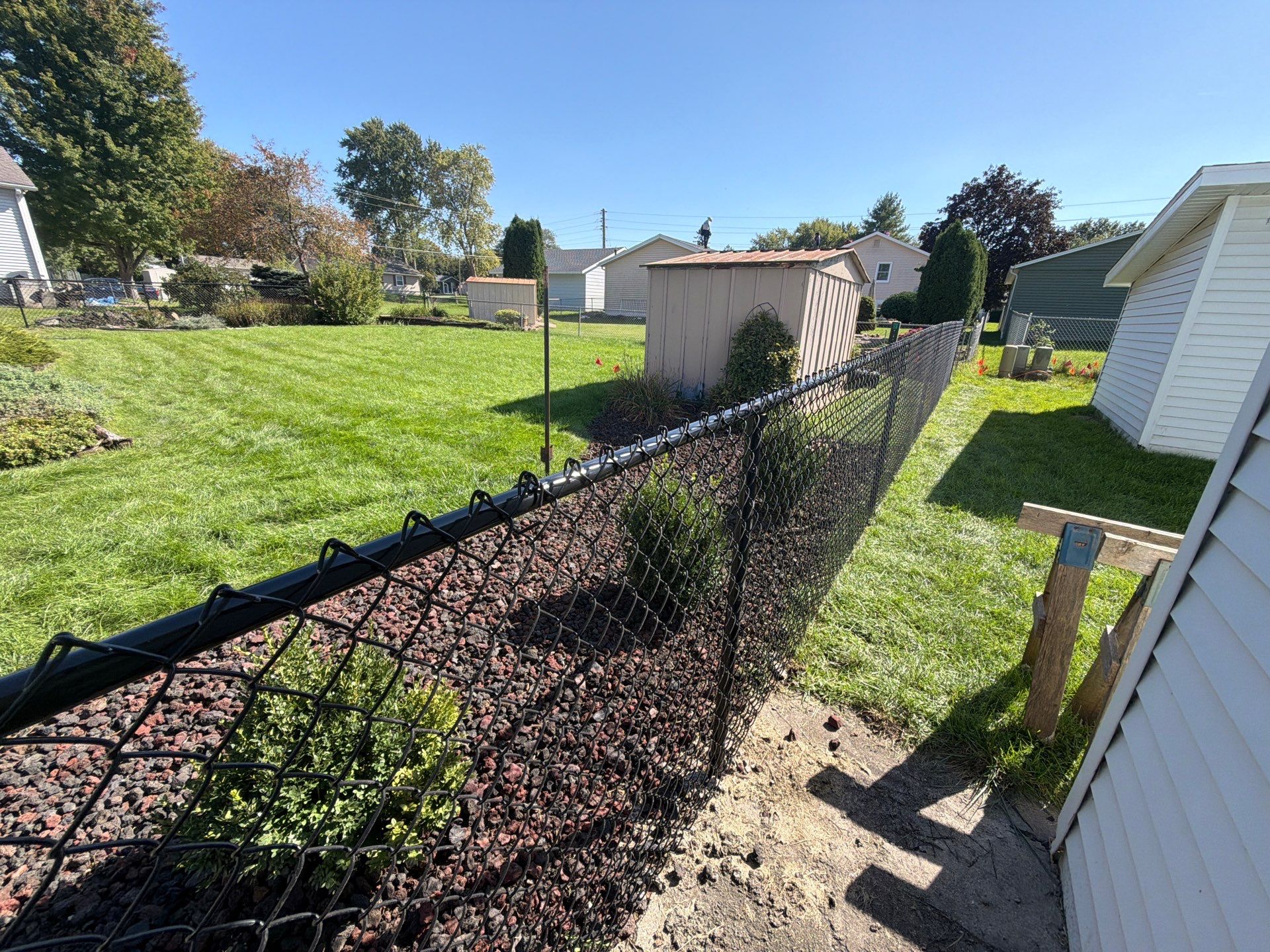 Custom Vinyl Privacy and Black Chain Link Fence Installation in Cedar Falls by Perfect Picket Fence and Stain