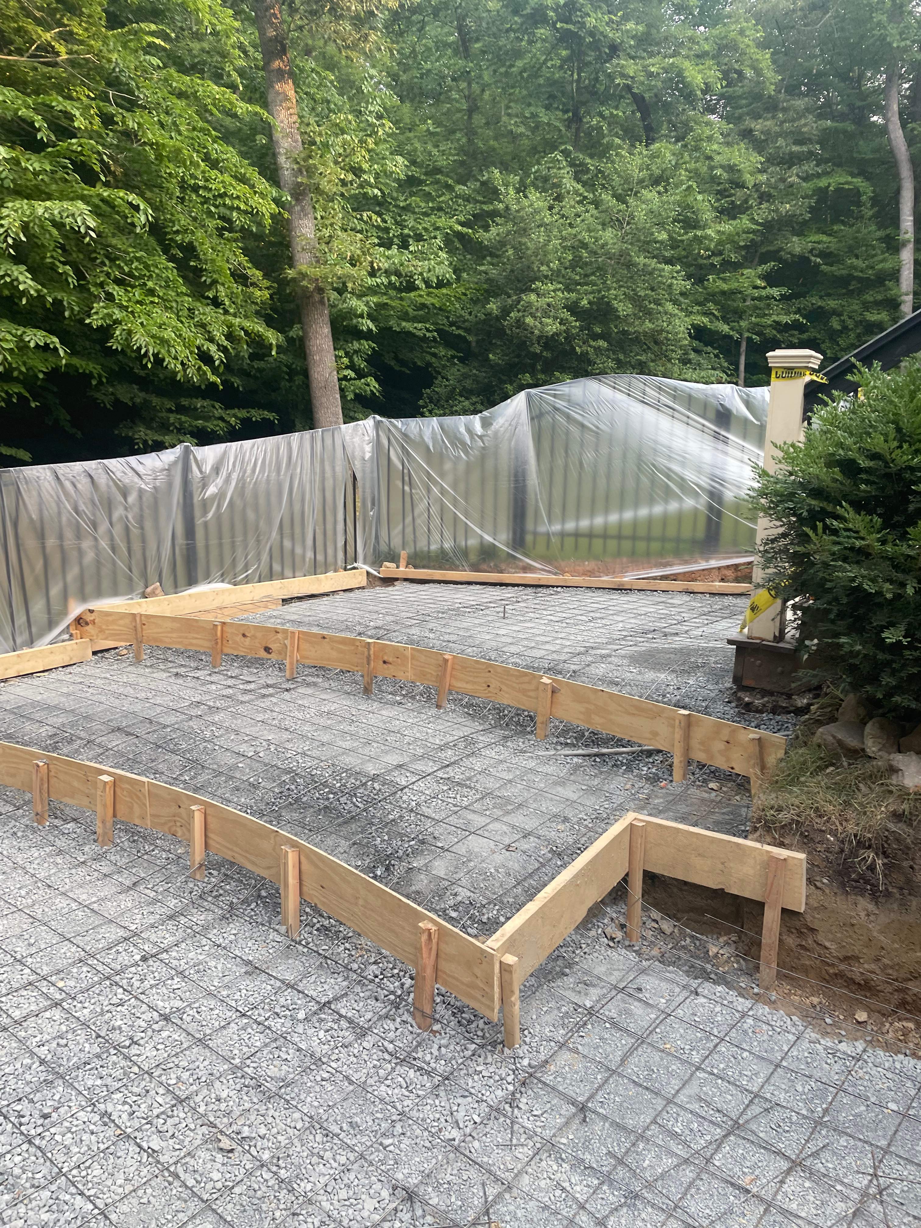 Pool Surround remodel with retaining walls, new waterfall and water slide by Fairfax Contractors, LLC