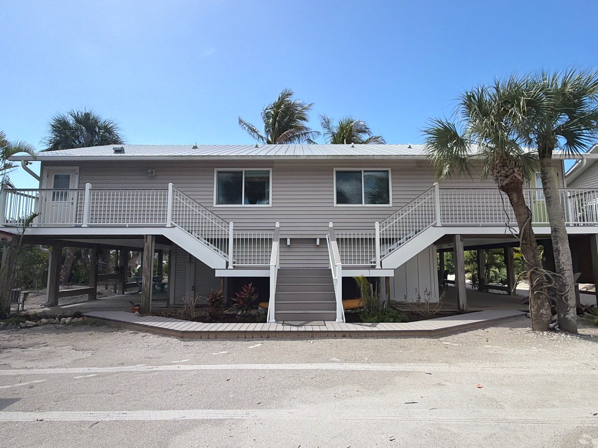Elevated Coastal Home Renovation with Siding and Custom Decks in Englewood