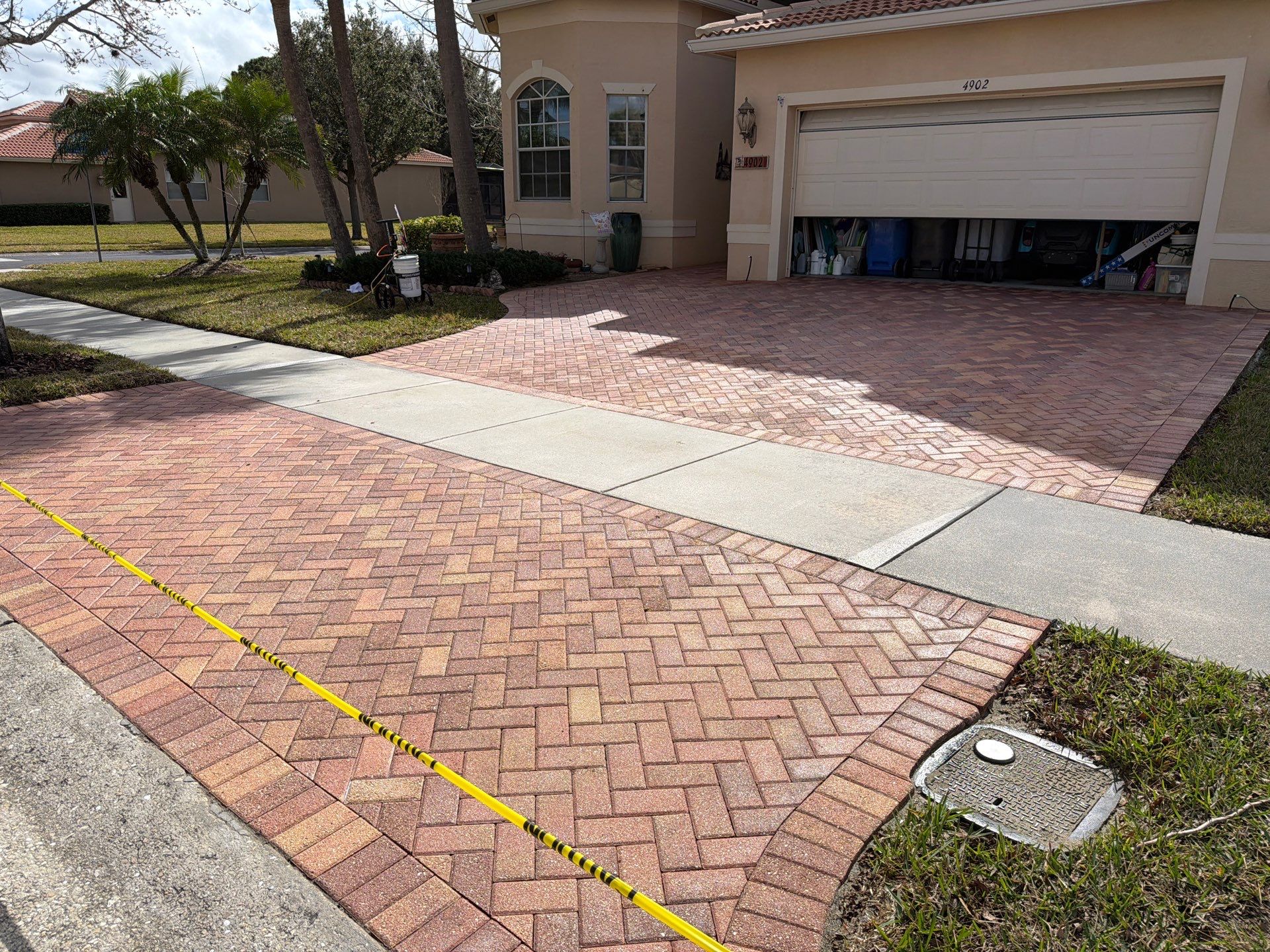 Paver Sealing for Herringbone Driveway and Screened Lanai in Valencia Lakes by Supreme Paver Experts