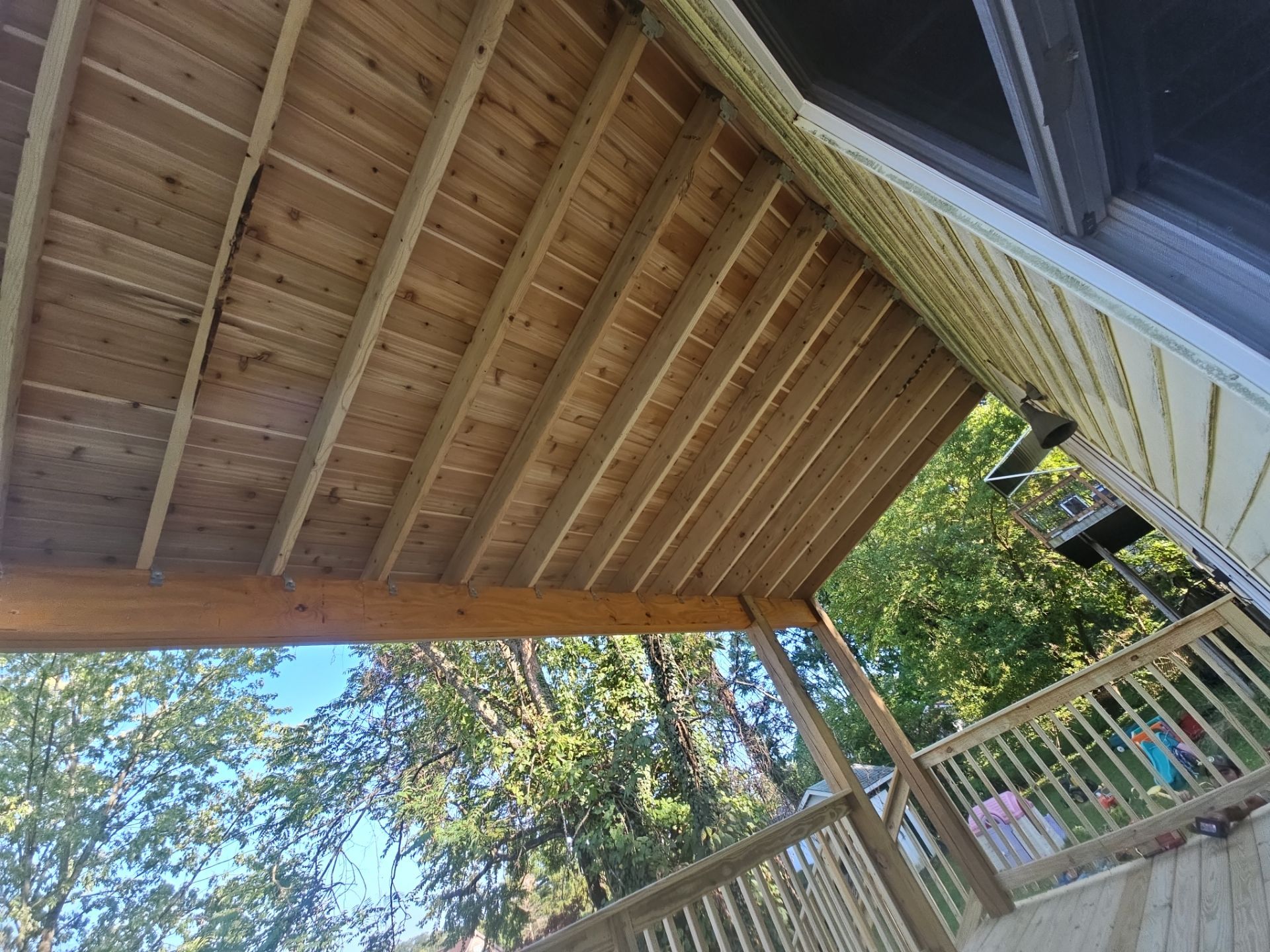 Deck and shed roof by Cousins Roofing Siding & Decks