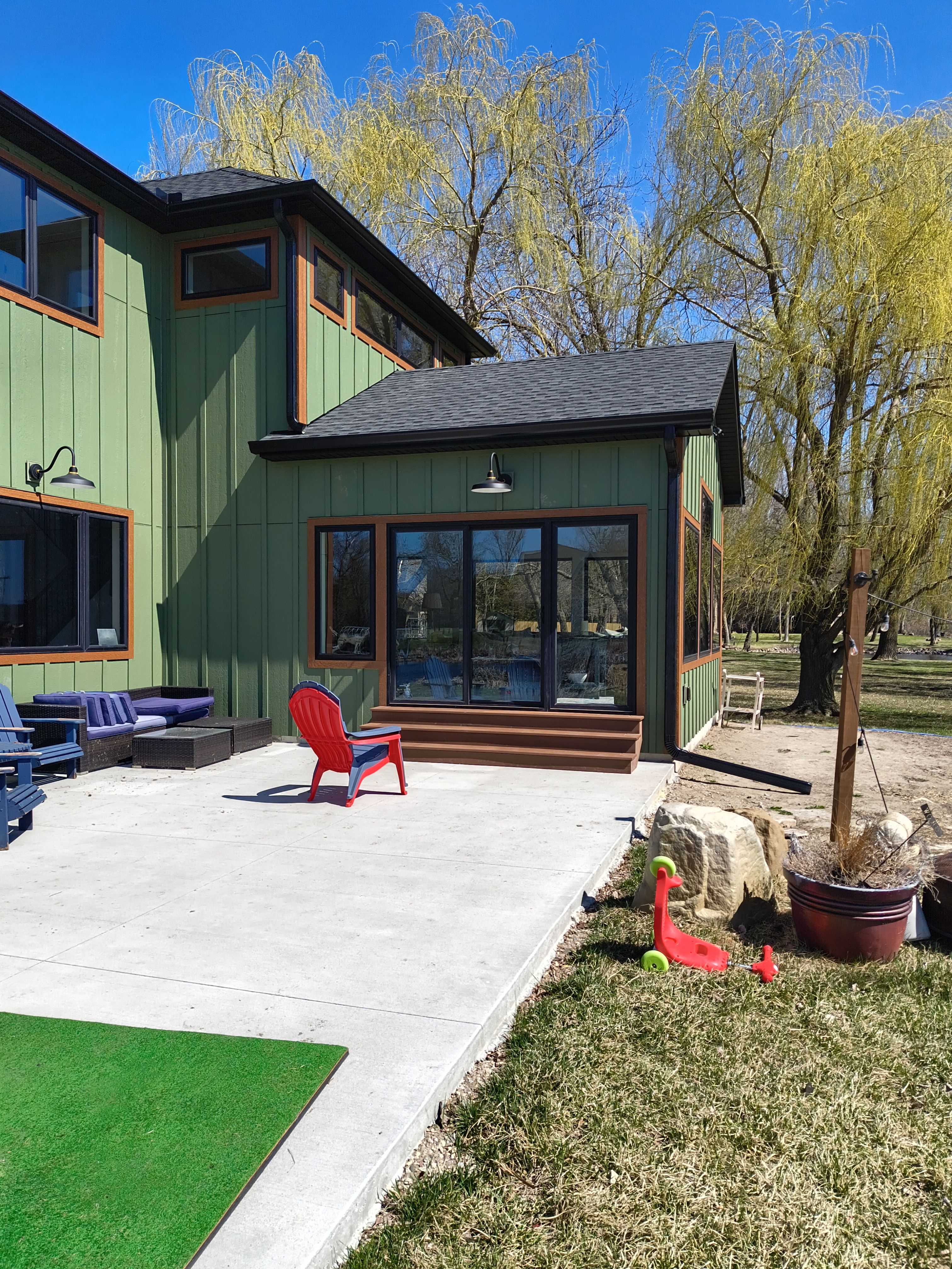 Seamless Gutter Installation in Annandale MN | 6” Black Gutters on Green Home by Next Level Seamless Gutters / Exteriors Inc.
