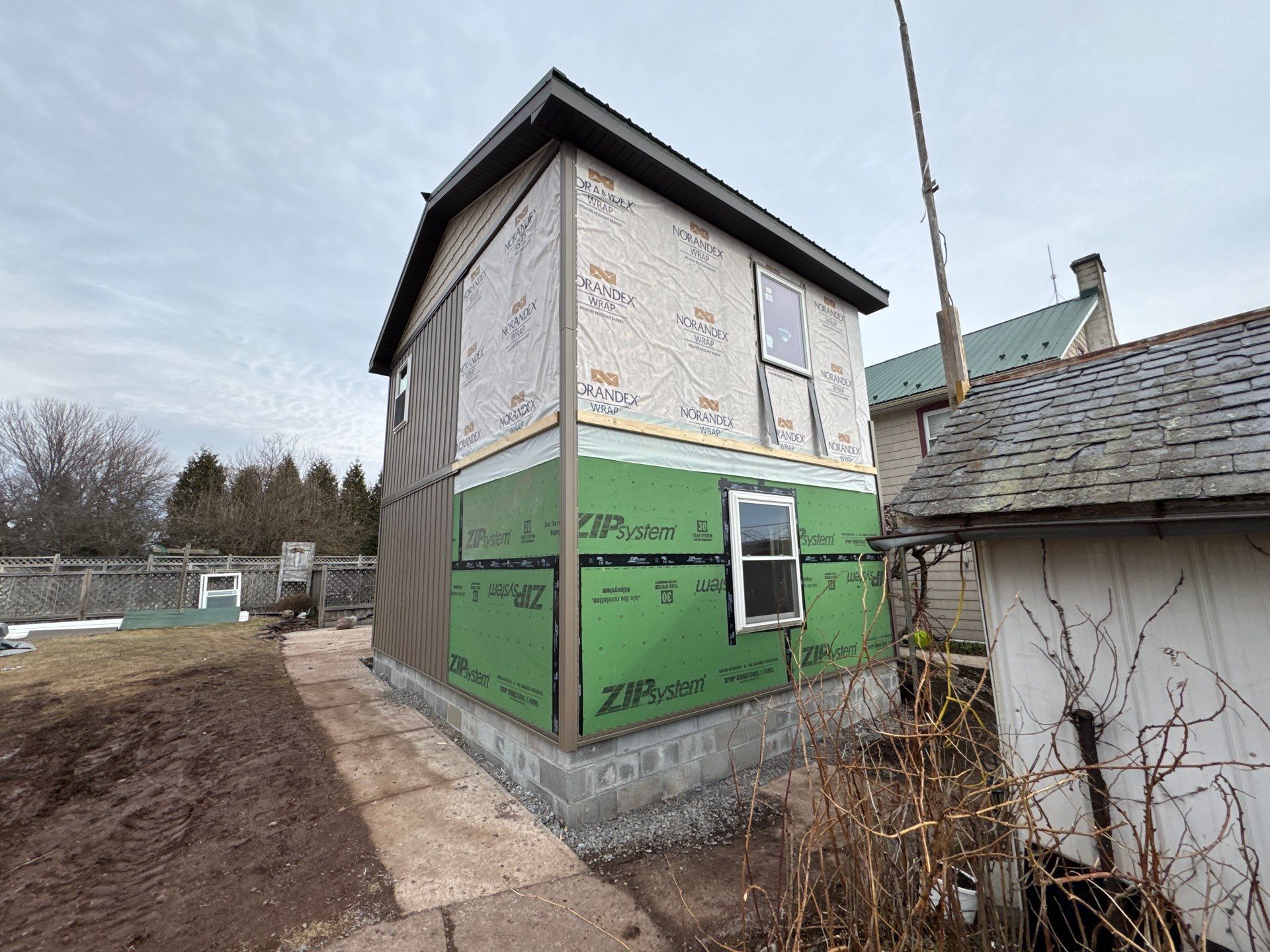 Multi-Story Residential Addition Featuring Textured Metal Siding in Millersburg by Esh Builders
