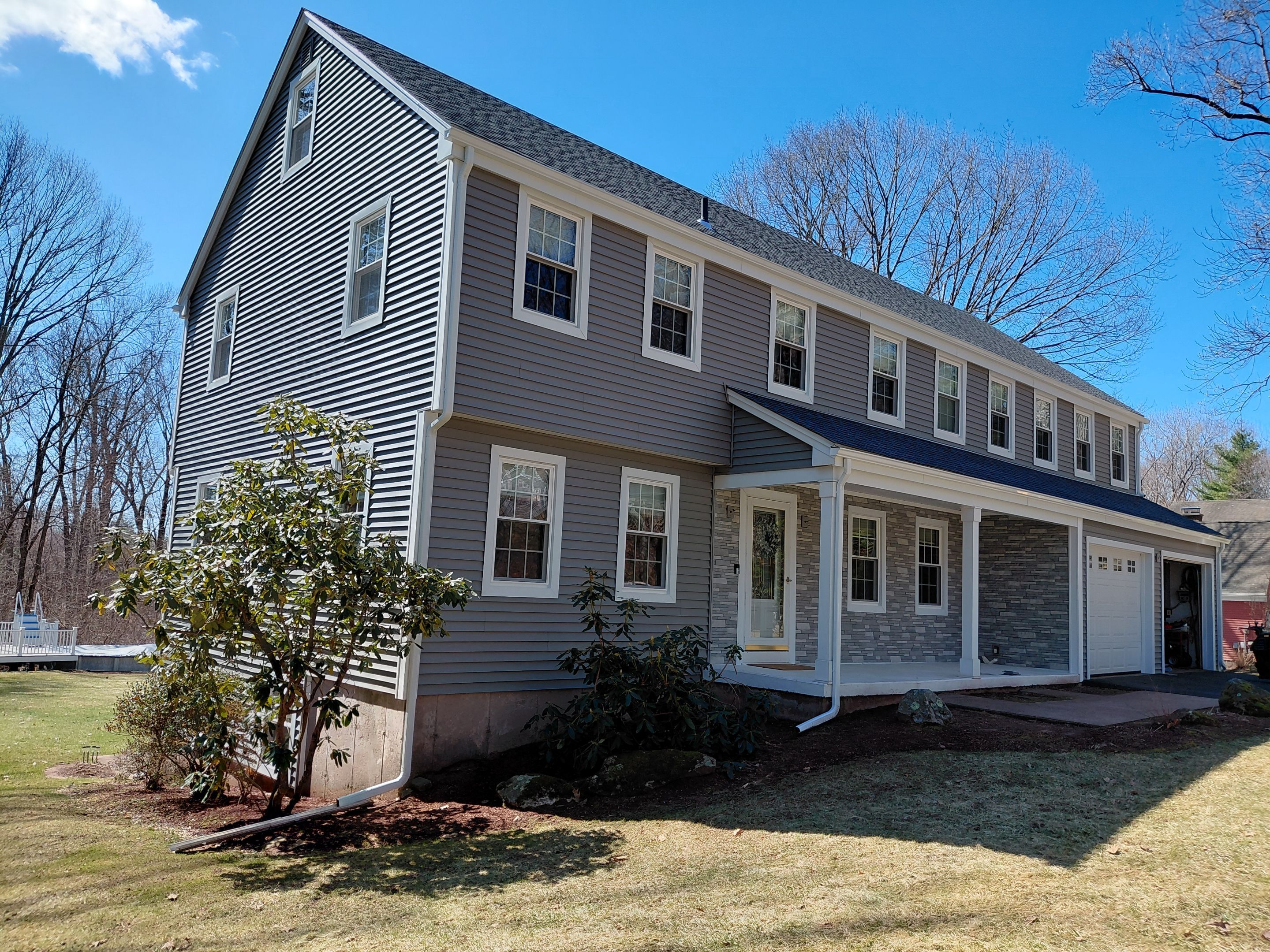 Glastonbury Exterior Renovation with Castle Stone Siding & Stone Entry Upgrade by Turner Home Improvement Contractors, LLC