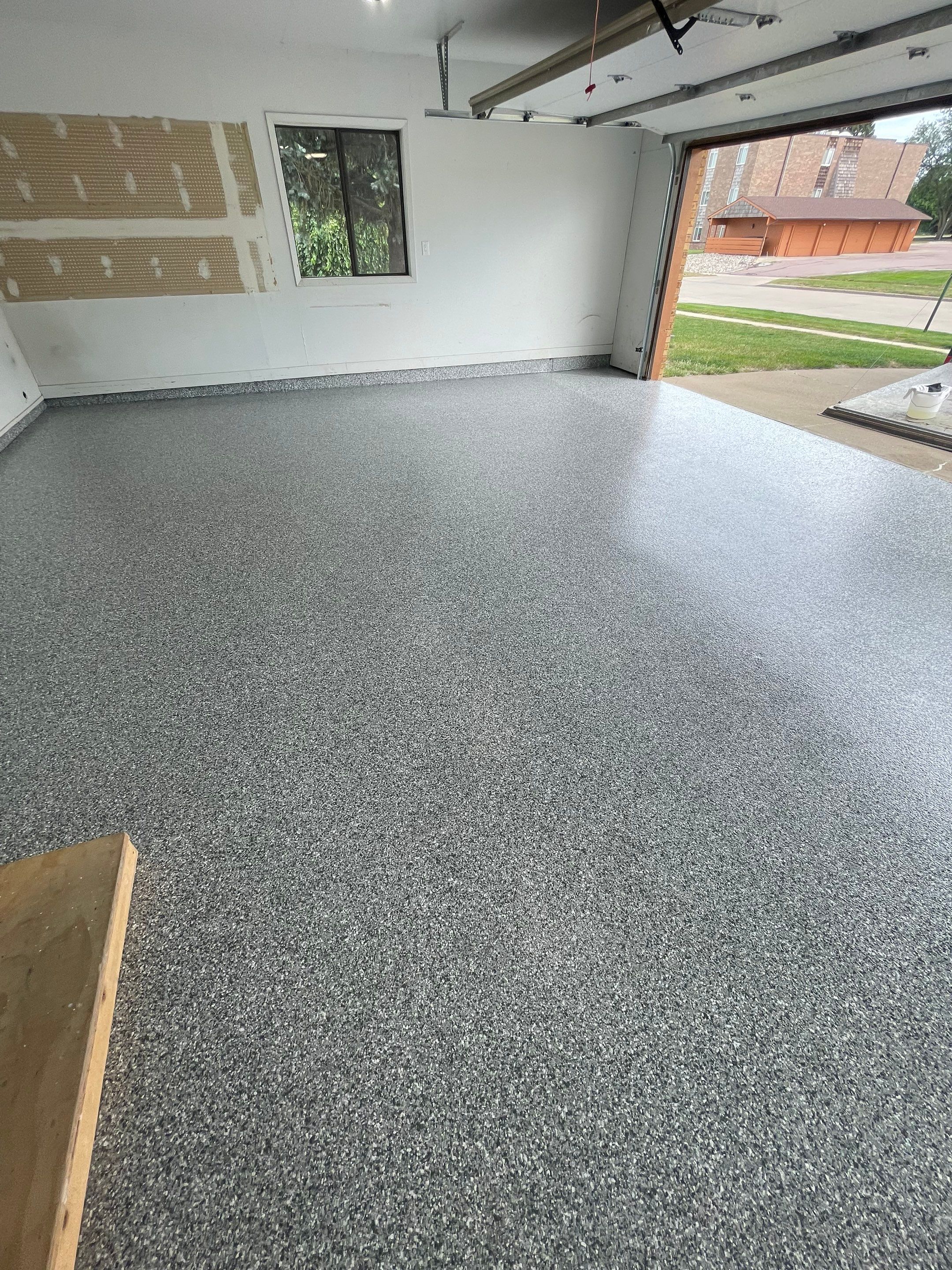 Grey Speckled Concrete Coating for Residential Garage in Yankton by Select Painting, Coatings & Garage Cabinets