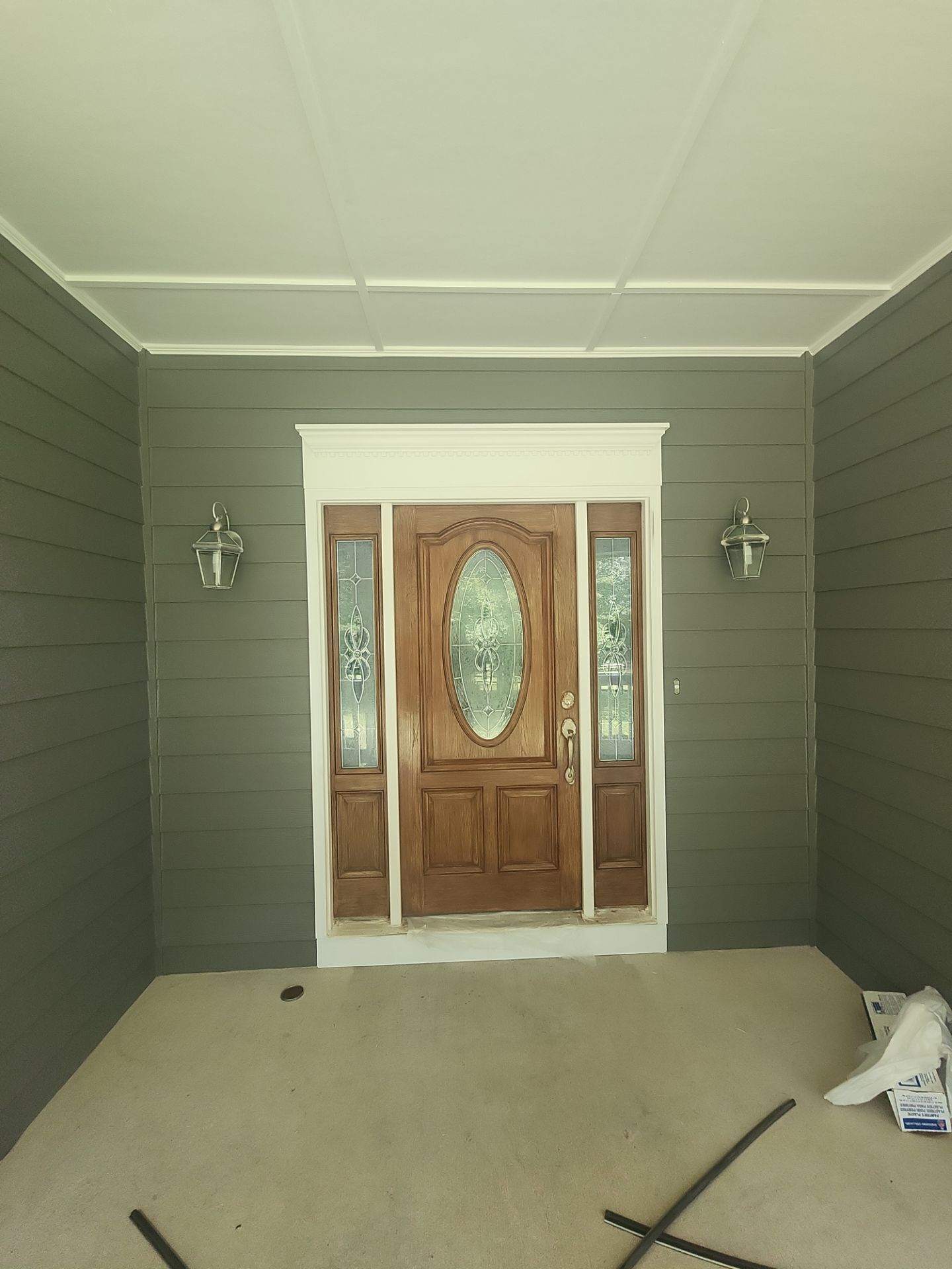 Siding replacement, exterior painting, and front door staining. by GonzalezPainters & Contractors Inc
