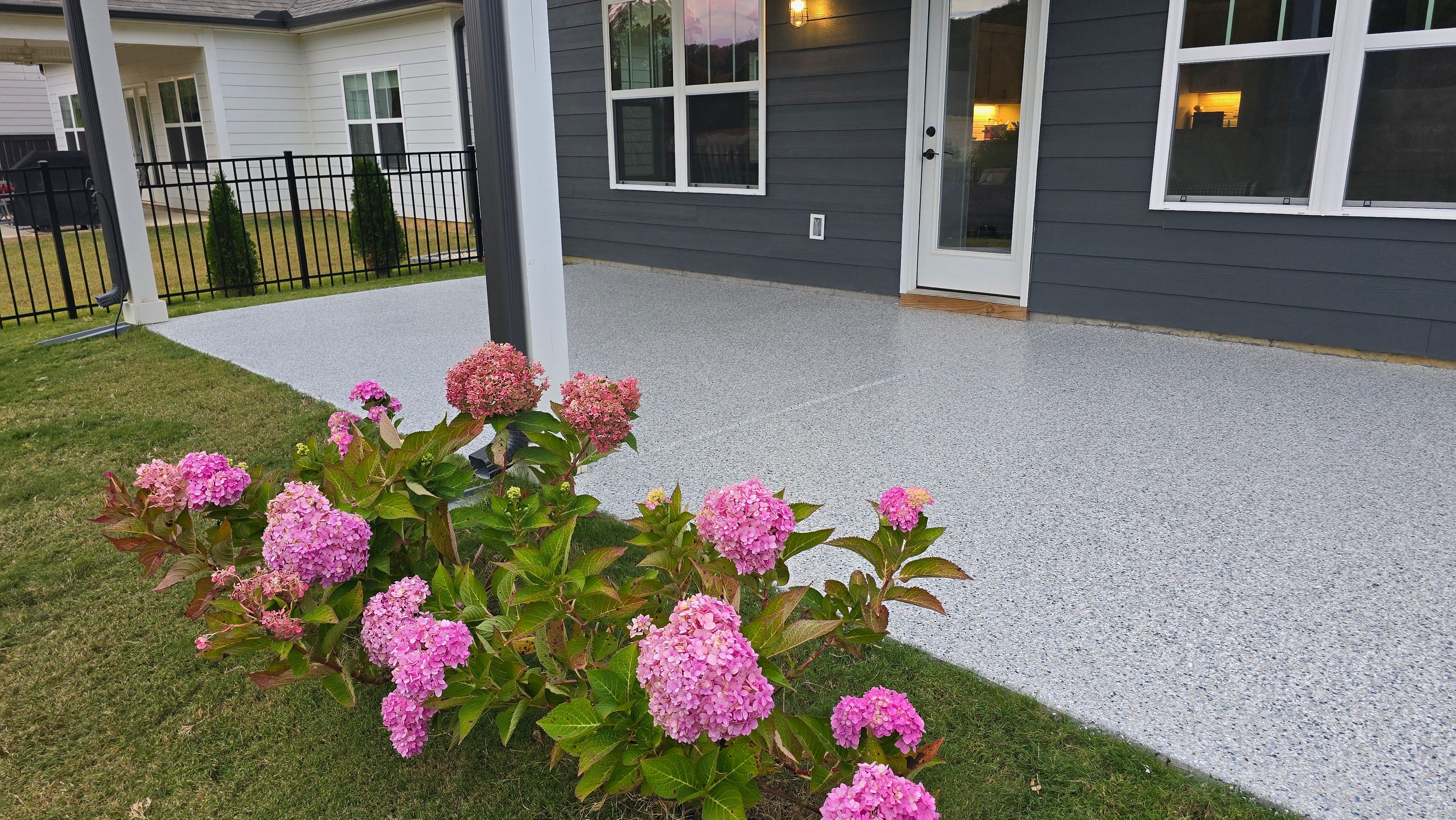 Sidewalk, Porch, and Back Patio Using Creekbed and Nordic Green by Elite Floor Solutions